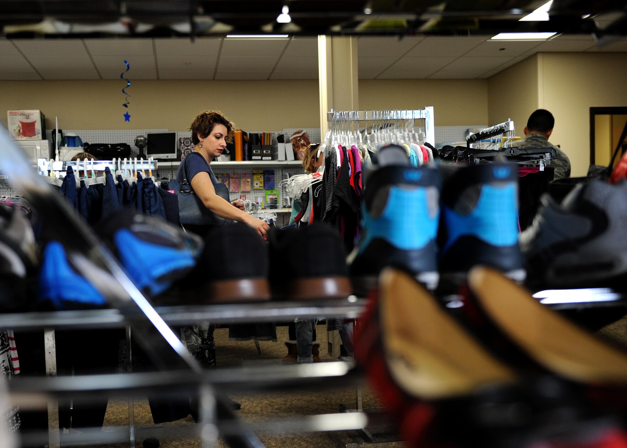 Customers browse for clothes and other items March 7, 2017, at the Airman’s Attic on Little Rock Air Force Base, Ark. Families are encouraged to continue the cycle of giving, by donating items to ease the transition of moving for other families. (U.S. Air Force photo by Airman 1st Class Grace Nichols)