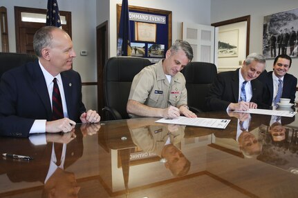 NSWC IHEODTD Commanding Officer Capt. Scott Kraft and College of Southern Maryland President Dr. Bradley Gottfried sign a five-year Education Partnerhship Agreement, here Jan. 30, as NSWC IHEODTD Technical Director Ashley Johnson (left) and CSM Director of Entrepreneur & Innovation Institute Thomas Luginbill (right) look on. 