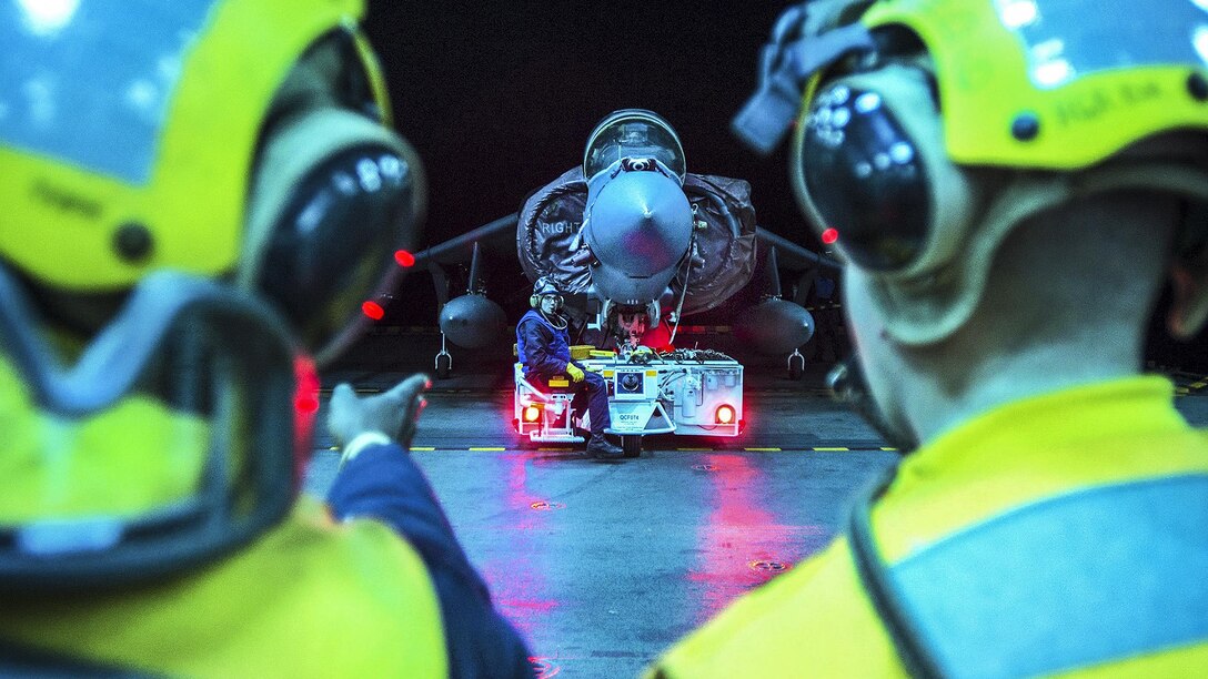 Sailors re-spot an AV-8B Harrier using the starboard aircraft elevator aboard the USS Bonhomme Richard in the Philippine Sea, March 10, 2017. The ship is operating in the Indo-Asia-Pacific region to enhance warfighting readiness, prepared for any contingency. Navy photo by Petty Officer 2nd Class Diana Quinlan