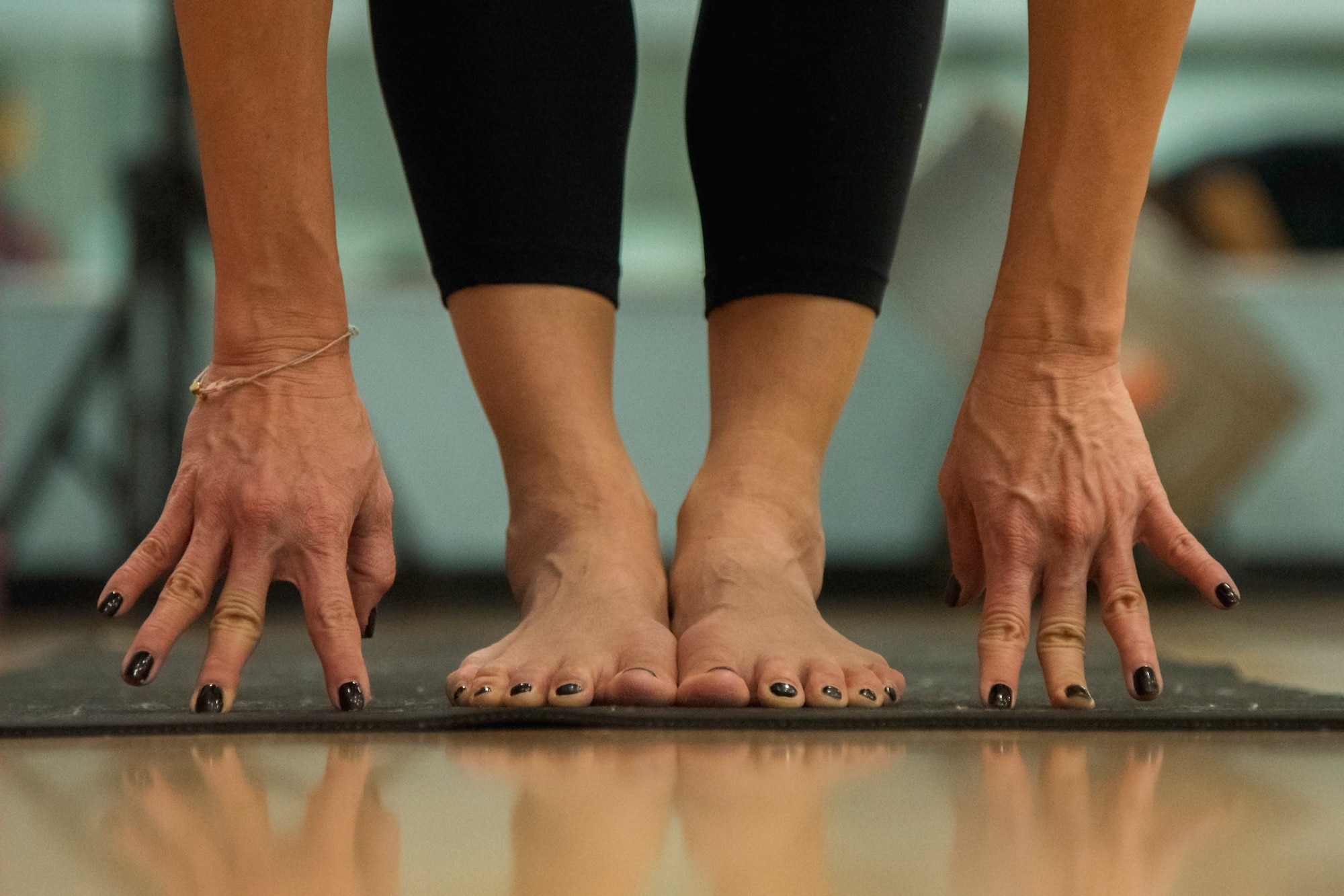 Le Nguyen, West Fitness Center yoga instructor, stretches during her yoga session at Joint Base Andrews, Md., March 9, 2017. Nguyen, a retired U.S. Air Force colonel, has been volunteering as a yoga instructor at JBA since October 2015. (U.S. Air Force photo by Airman 1st Class Valentina Lopez)