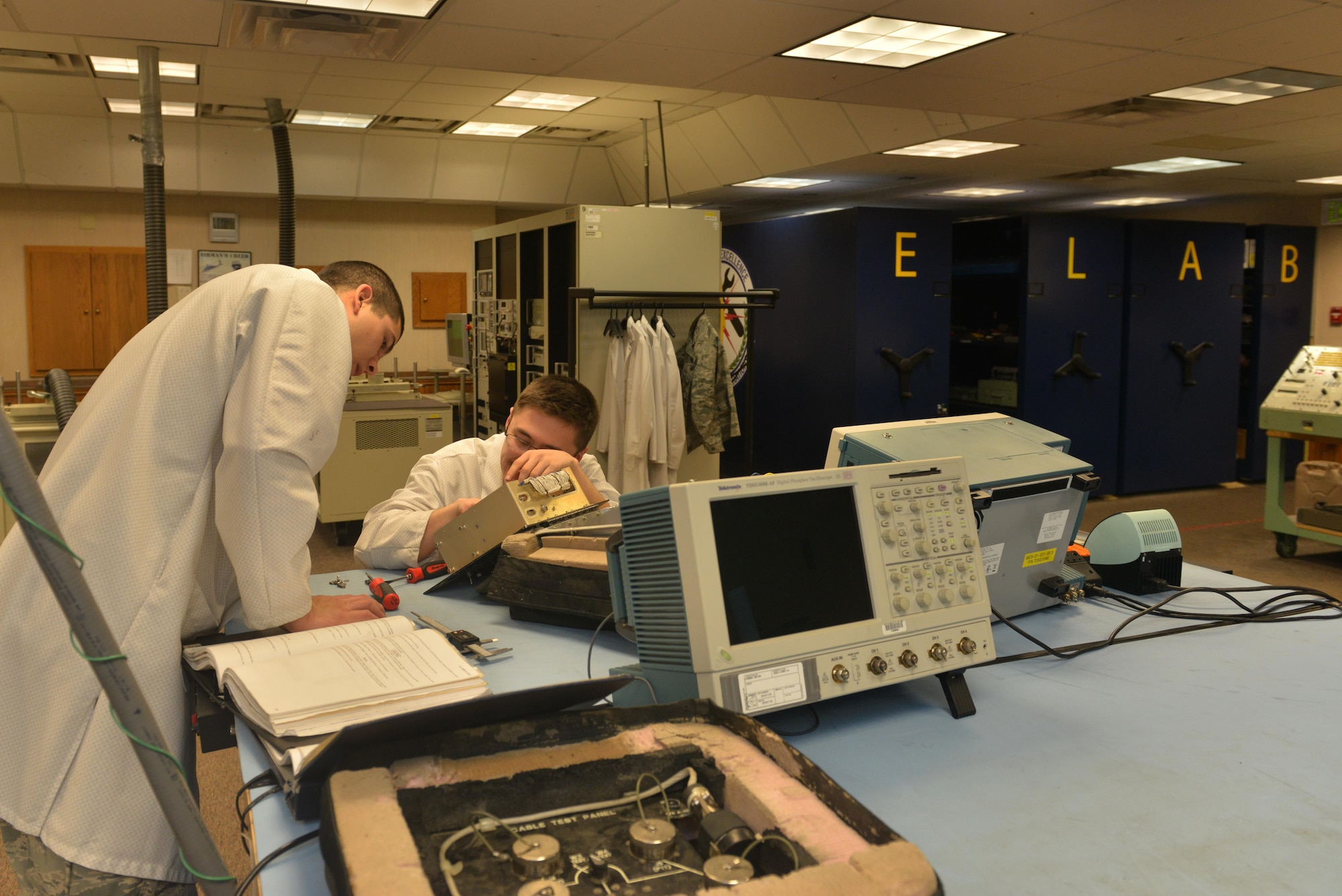 (From left) Staff Sgt. Dylan Wood, 791st Maintenance Squadron electronics laboratory trainer, and Senior Airman Maxwell Clement, 791st MXS ELAB technician, remove faulty components from a controller monitor at Minot Air Force Base, N.D., March 2, 2017. Electronic laboratory technicians are responsible for maintenance and quality assurance of the Minuteman III Intercontinental Ballistic Missile support equipment. (U.S. Air Force photo/Airman 1st Class Jessica Weissman)
