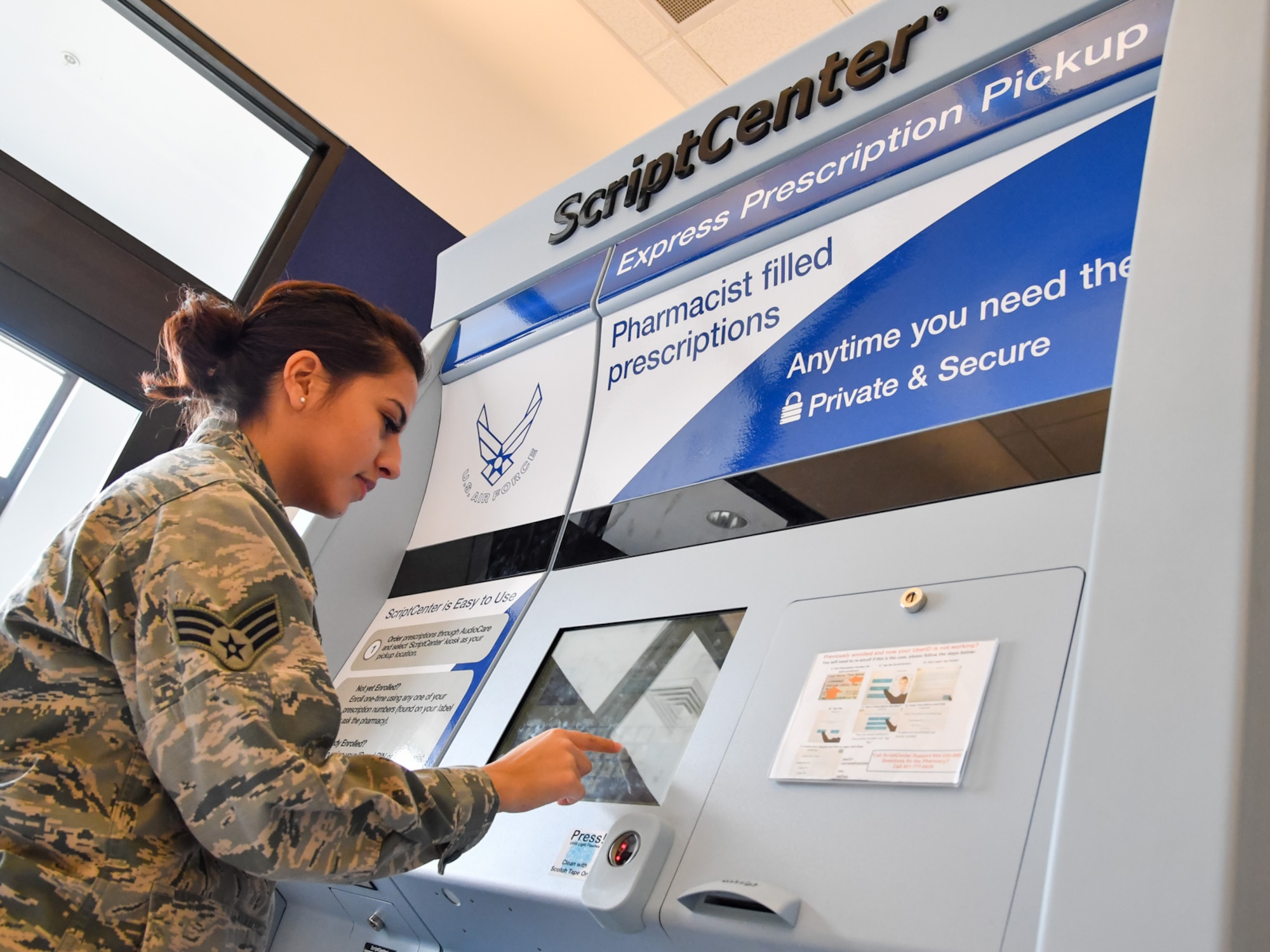 Senior Airman Samantha Laredo uses the prescription kiosk outside the Staff Sgt. Derek F. Ramos Satellite Pharmacy inside the Hill Air Force Base Exchange, March 10. The ScriptCenter kiosk provides TRICARE beneficiaries expanded pharmacy access to pick up refills during weekends, holidays (excluding Thanksgiving and Christmas), and weekdays after hours until 7 p.m., or anytime the Exchange is open. (U.S. Air Force/R. Nial Bradshaw)