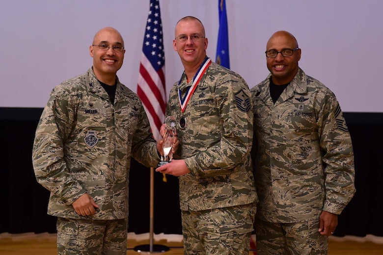 Master Sgt. Robert Hotzfeld, 460th Mission Support Group first sergeant accepts the 2016 14th Air Force First Sergeant of the Year award from 460th Space Wing commander, Col. David Miller, Jr. and 460th SW Command Chief Master Sgt. Rodney Lindsey. Hotzfeld competed against hundreds of other first sergeants across the Air Force for this award. (courtesy photo)