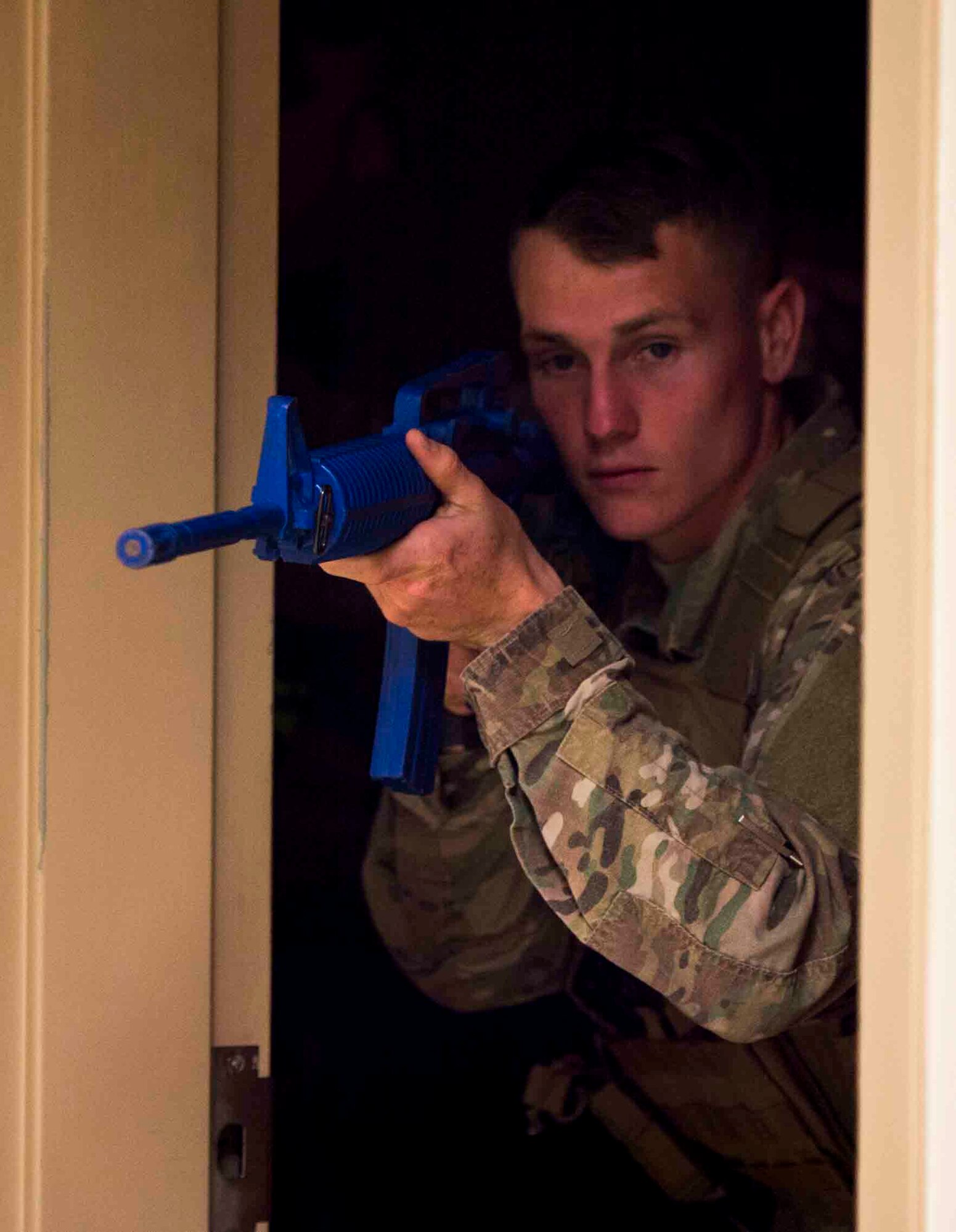 An Air Commando with the 1st Special Operations Security Forces Squadron prepares to leave a room after deeming it clear during an active shooter exercise at Hurlburt Field, Fla., March 10, 2017. New procedures to increase wounded victim survivability were implemented for tactical responders. (U.S. Air Force photo by Senior Airman Krystal M. Garrett) 