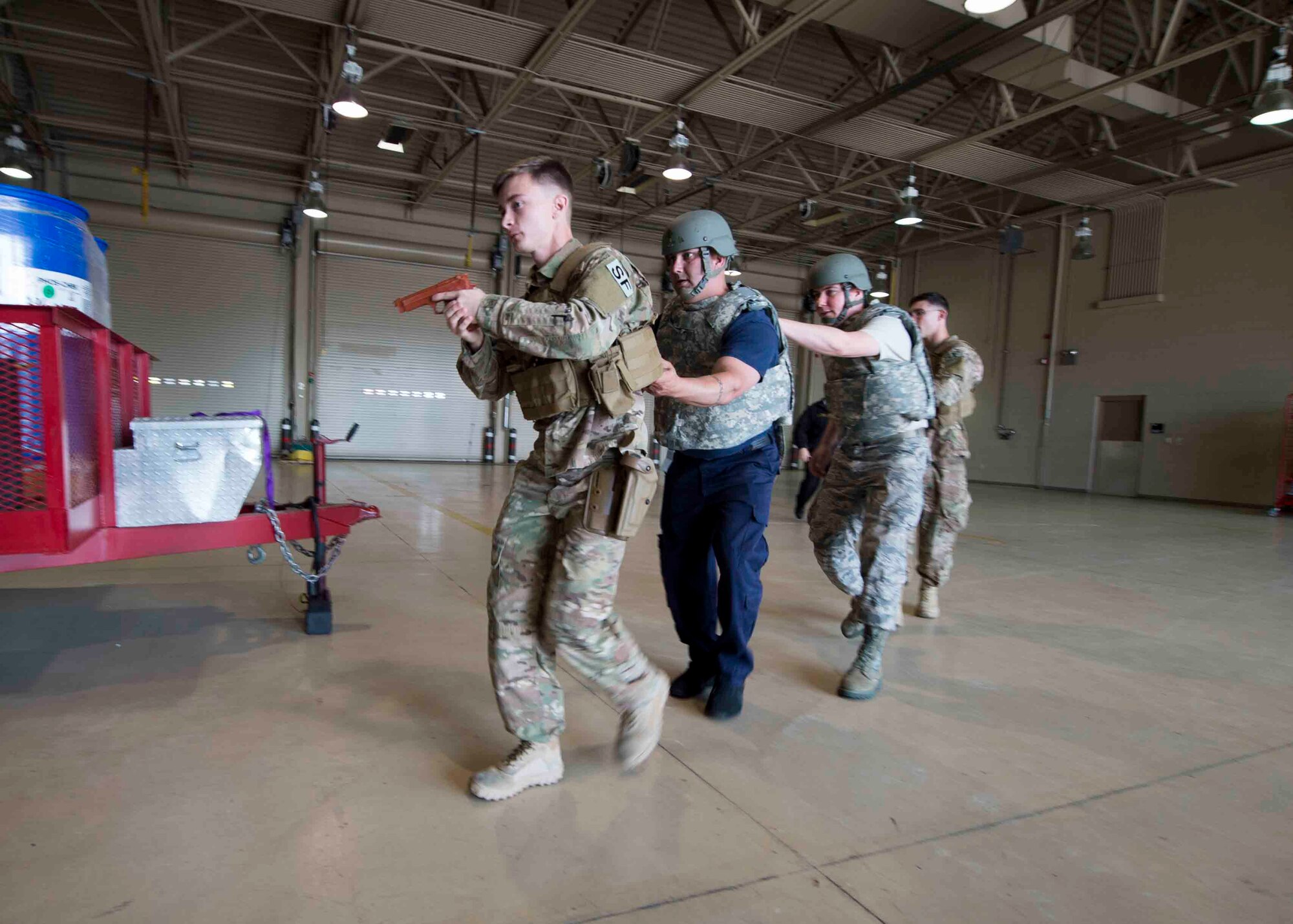 Air Commandos with the 1st Special Operations Security Forces Squadron and the 1st Special Operations Civil Engineer Squadron perform first responder duties during an active shooter exercise at Hurlburt Field, Fla., March 10, 2017. Air Commandos with the 1st Special Operations Security Forces Squadron, 1st SOCES and the 1st Special Operations Medical Group participated in an exercise to practice new procedures for tactical responders. (U.S. Air Force photo by Senior Airman Krystal M. Garrett)