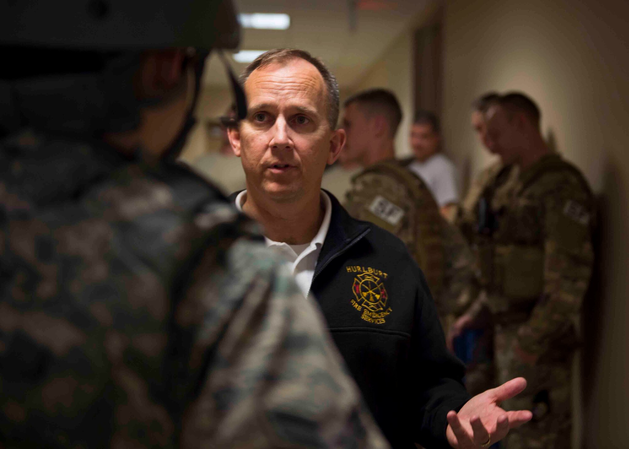 Christopher Maxwell, assistant fire chief of training for the 1st Special Operations Civil Engineer Squadron, explains procedures to an Air Commando during an active shooter exercise at Hurlburt Field, Fla., March 10, 2017. The exercise was held to implement new procedures for tactical responders and aide in increasing survival chances of wounded victims. (U.S. Air Force photo by Senior Airman Krystal M. Garrett)