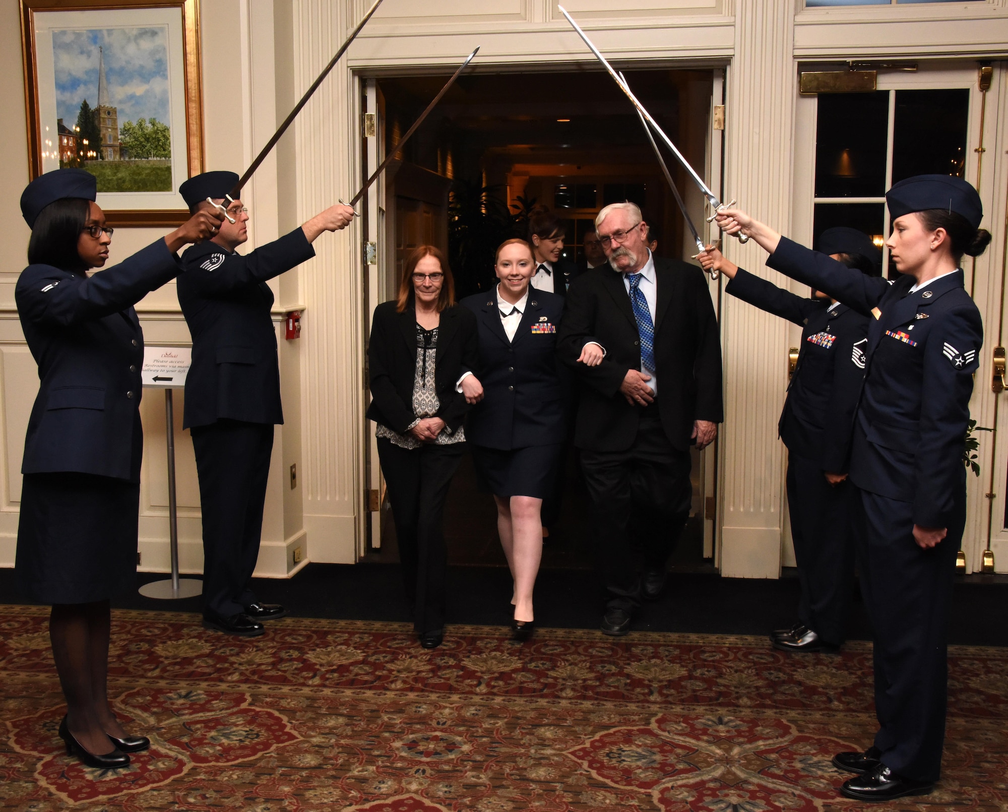 NEWARK, DE- Staff Sgt. Gabrielle Rieker, family readiness program manager, 166th Airlift Wing, enters the Deerfield Golf and Tennis Club ballroom with her parents Laura and Bill Rieker, during the Delaware Air National Guard Annual Enlisted Recognition Banquet held on March 4, 2017. Rieker received the 2016 Airman of the Year Award, which is awarded to an airman between the rank of E1-E4 for stellar performance and going above and beyond. (U.S. Air National Guard photo by Tech. Sgt. Gwendolyn Blakley/ Released).