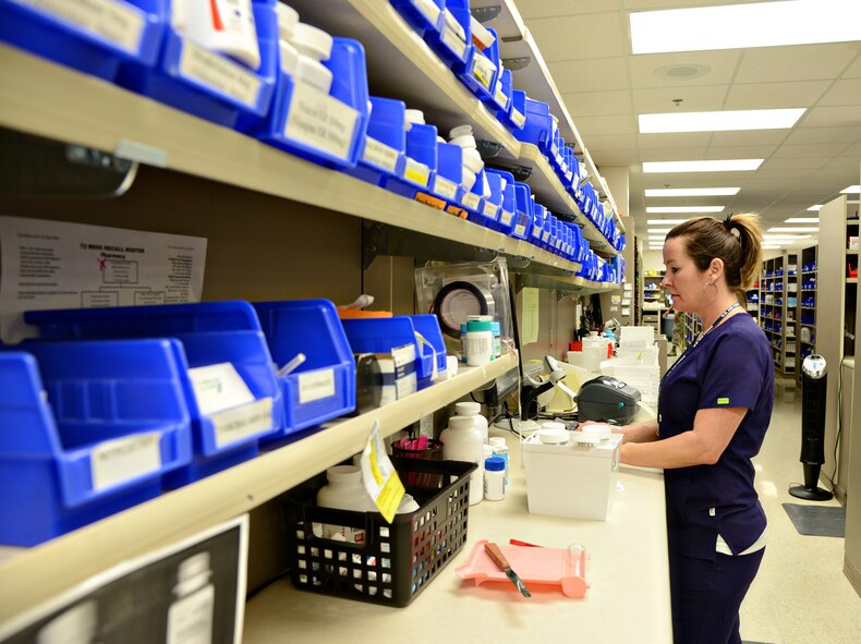 With a growing stack of bins to her right, Brenda Daniels, a pharmacy technician with the 72nd Medical Support Squadron, fills a multitude of prescription orders. (Air Force photo by Kelly White)