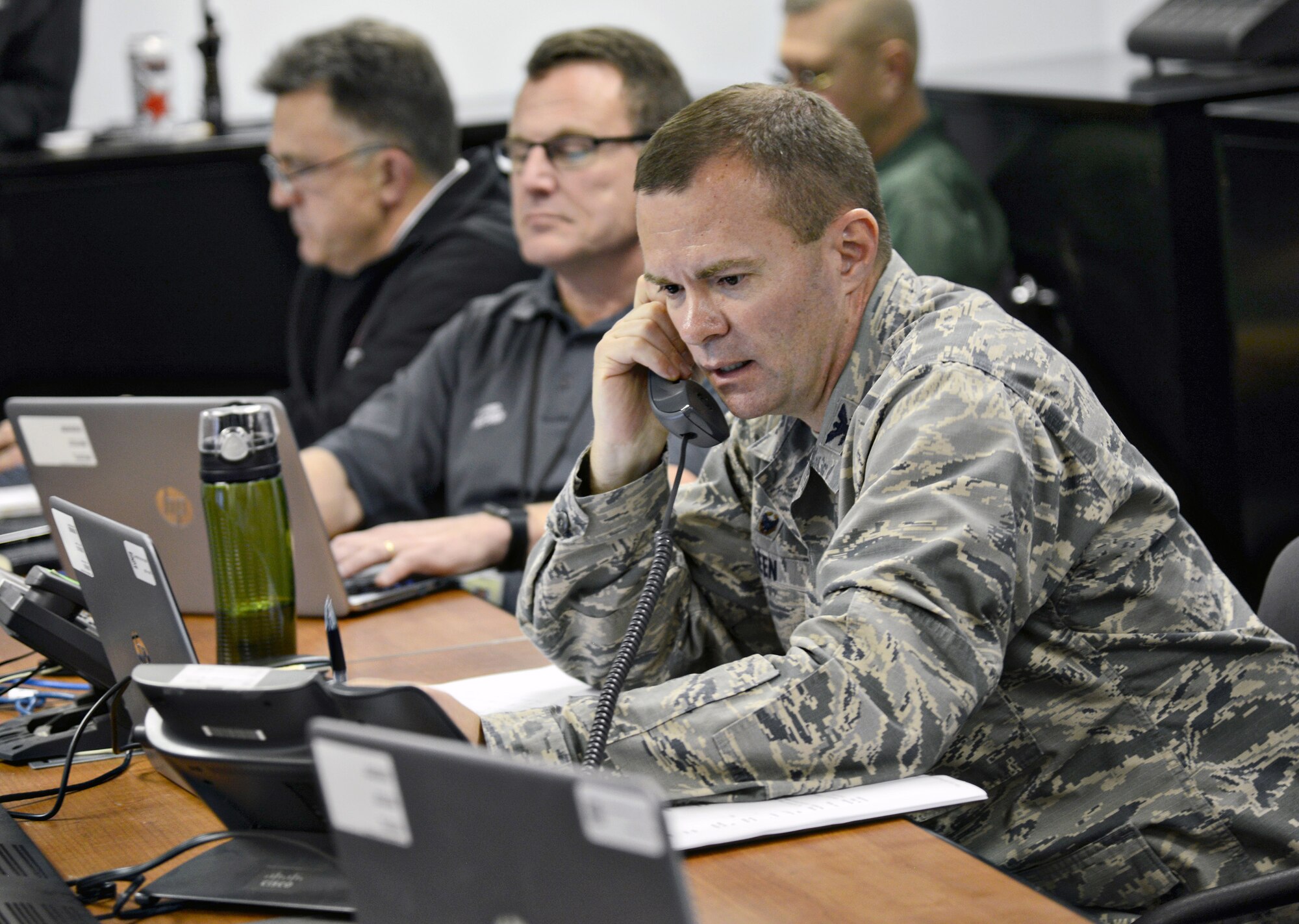 A Continuity of Operations (COOP) exercise was held Feb. 28, as part of an Air Force annual requirement. A COOP is usually held within 12-24 hours after an emergency situation to assess damage of property and to figure out what is needed to make the mission fully operational again. Pictured here, from right, 72nd Mission Support Group Commander Col. Michael Green, the Emergency Operations Center (EOC) Director, and Tinker Fire and Emergency Services Chief Terry Ford and Scott Bloxham work in the EOC during last week’s COOP exercise. The EOC is the C2 support element that coordinates information and resources to support the installation’s actions before, during and after an incident at the operational level, and is the focal point for the development and coordination of the follow-on operations and recovery plan. (Air Force photo by Kelly White)