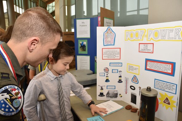 Capt. Jeremy, 963rd Airborne Air Control Squadron, listens as a student inventor explains his idea for alternative energy during the 28th annual Oklahoma Student Inventors Exposition held at Rose State College, Feb. 28. More than 20 members of the 552nd Air Control Wing volunteered to serve as judges. The expo featured 180 students in grades 2 to 12 from 22 schools across the state.  (Air Force photo by Ron Mullan)