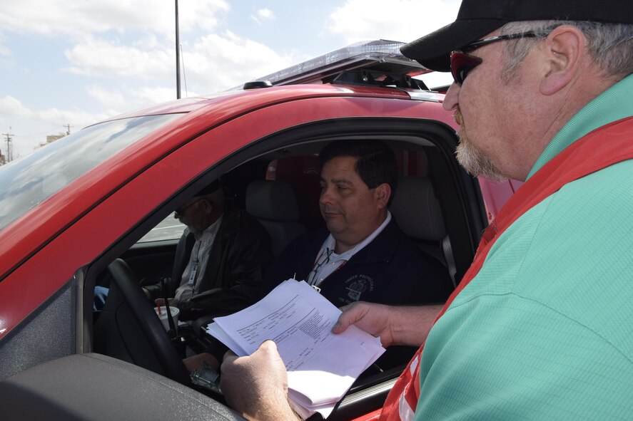 Scott Lindsey, right, 72nd Air Base Wing Inspector General office exercsie controller, monitors the emergency response times for fire and police with Michael Tuley, 72nd Civil Engineer Fire Department training officer, as the claxon sounds during the War Wagon 17-01 natural disaster preparedness exercise and tornado drill Feb. 27, 2017, Tinker Air Force Base, Oklahoma. Due to the frequent occurance of tornados and damaging weather in the region, Tinker AFB regularly holds exercises to ensure appropriate responses by the population and emergency crews. (U.S. Air Force photo/Greg L. Davis)