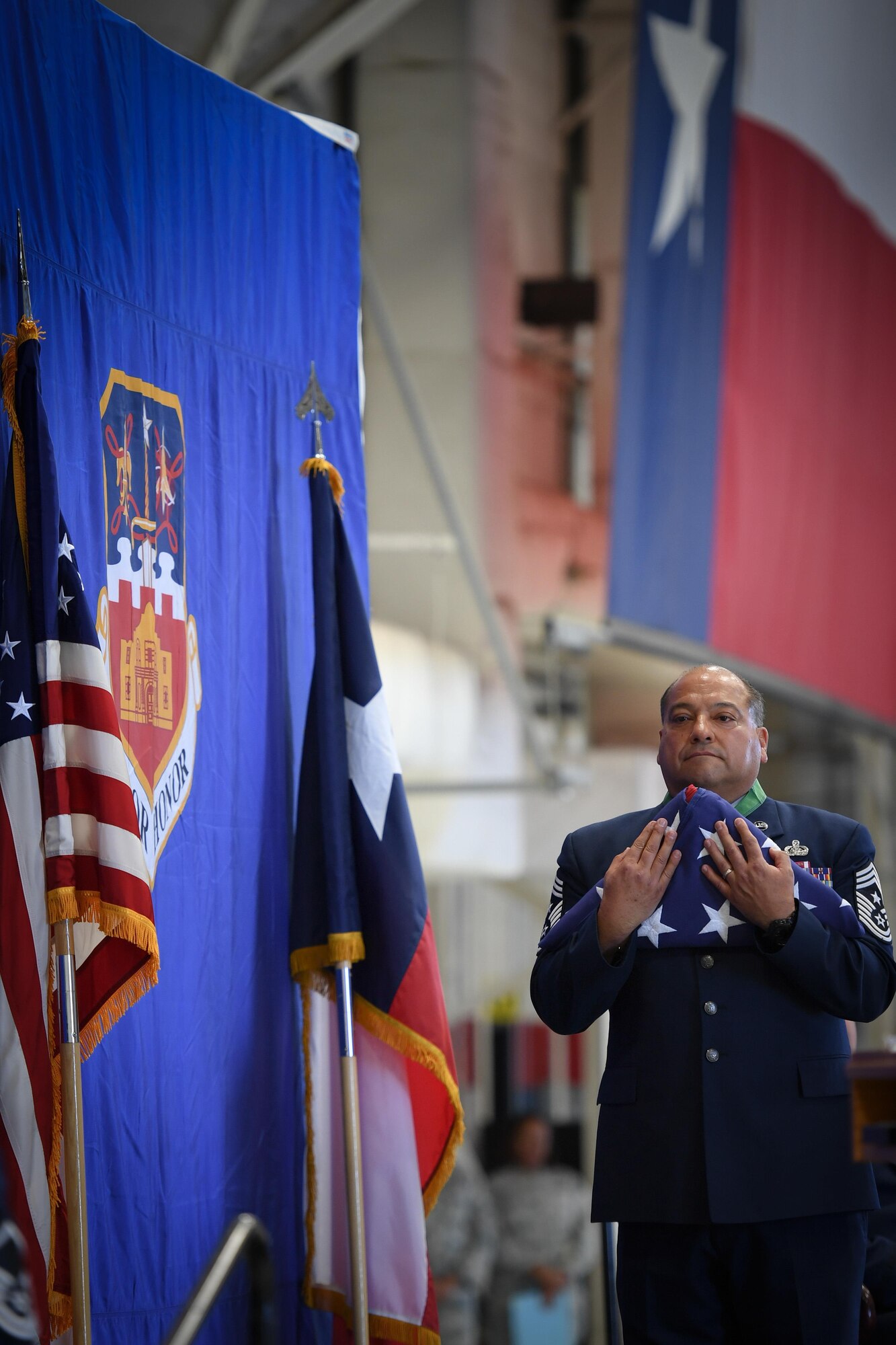 Command Chief Master Sgt. George Longoria holds an American flag during his retirement ceremony at Joint Base San Antonio-Lackland, Texas, Feb. 25, 2017. Longoria retires after 35 years of service with the 149th Fighter Wing, Texas Air National Guard. (U.S. Air National Guard photo by Tech. Sgt. Eric L. Wilson)