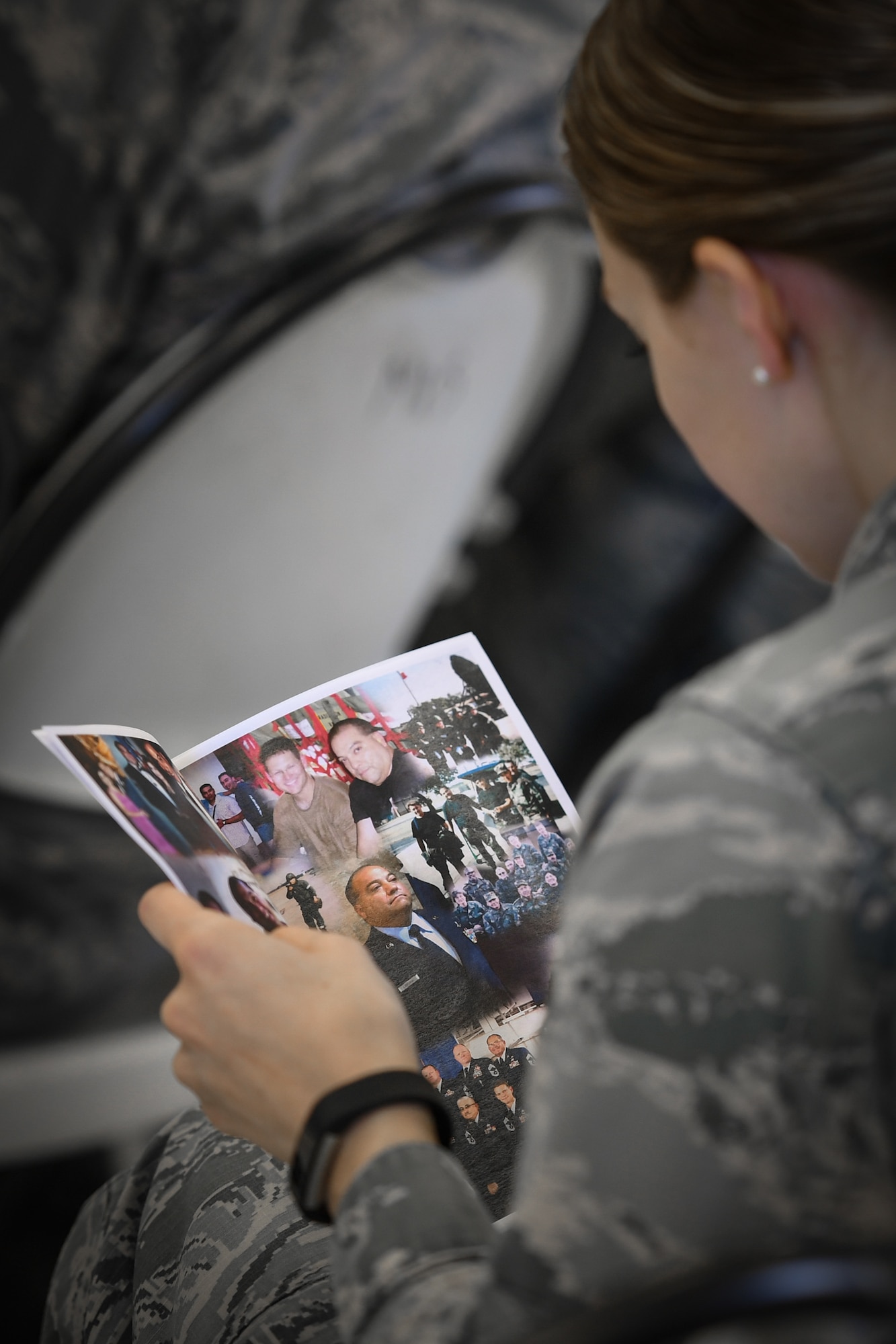1st Lt. Melissa Spencer, wing executive officer, looks at images of Command Chief Master Sgt. George B. Longoria, during a retirement ceremony honoring Longoria at Joint Base San Antonio-Lackland, Texas, Feb. 25, 2017. Longoria retires after 35 years of service with the 149th Fighter Wing, Texas Air National Guard. (U.S. Air National Guard photo by Tech. Sgt. Eric L. Wilson)