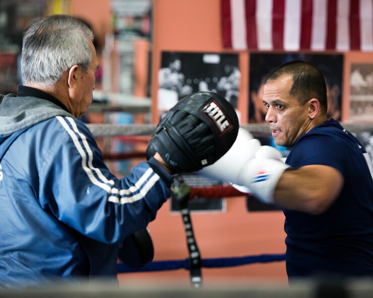 U.S. Air Force Capt. Eduardo Torrez, 60th Medical Operations Squadron, Travis Air Force Base, Calif., performs boxing drills with Jesse Lopez at the JL Tepito Boxing Club in Fairfield, Calif., Mar. 6, 2017. Torrez is a nurse at David Grant USAF Medical Center and was an amateur boxer before joining the Air Force. (U.S. Air Force photo/Louis Briscese)