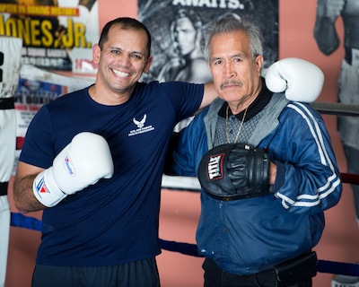 Air Force Capt. Eduardo Torrez, 60th Medical Operations Squadron, Travis Air Force Base, Calif., poses for a photo with Jesse Lopez at the JL Tepito Boxing Club in Fairfield, Calif., March 6, 2017. Torrez is a nurse at David Grant USAF Medical Center and was an amateur boxer before joining the Air Force. Air Force photo by Louis Briscese