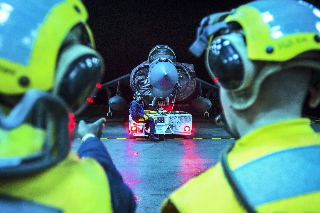 Sailors re-spot an AV-8B Harrier using the starboard aircraft elevator aboard the USS Bonhomme Richard in the Philippine Sea, March 10, 2017. The ship is operating in the Indo-Asia-Pacific region to enhance warfighting readiness, prepared for any contingency. Navy photo by Petty Officer 2nd Class Diana Quinlan