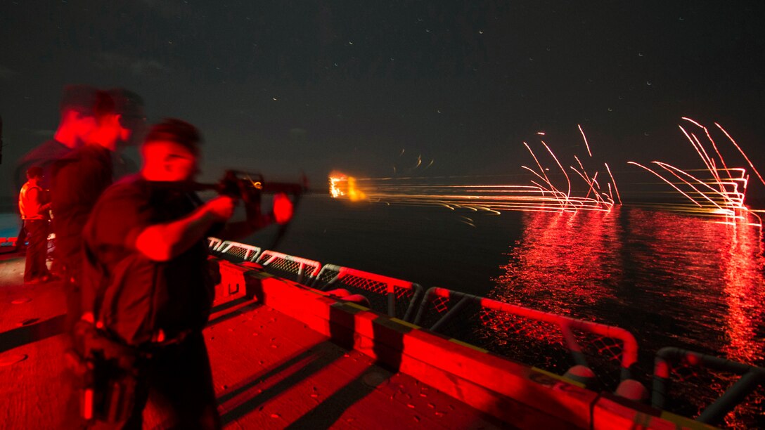 Navy Petty Officer 2nd Class Cepriano Trejo fires an M4A1 carbine during a low-light gun qualification aboard the amphibious assault ship USS Makin Island in the Arabian Sea, March 3, 2017. The ship is deployed in the U.S. 5th Fleet area of operations. Navy photo by Petty Officer 3rd Class Devin M. Langer