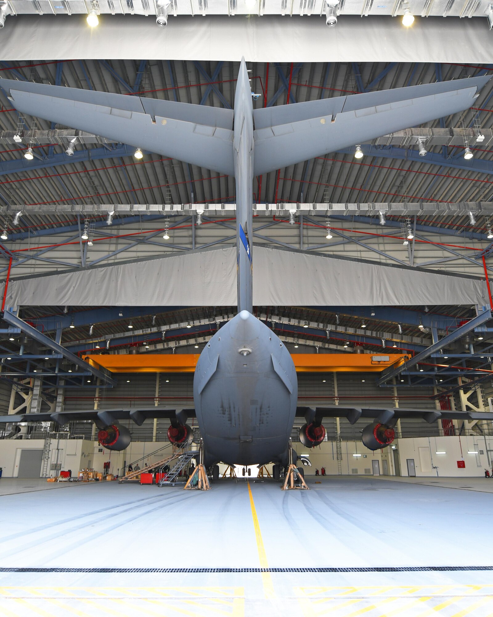A U.S. Air Force C-17 Globemaster III is lifted inside a Qatari hangar at Al Udeid Air Base, Qatar, Feb. 25, 2017. Weather conditions such as high winds required maintenance personnel to stop working on the C-17 for safety reasons, but by parking the aircraft in the Qatari hangar, the maintainers were able to work on it uninterrupted. (U.S. Air Force photo by Senior Airman Miles Wilson)