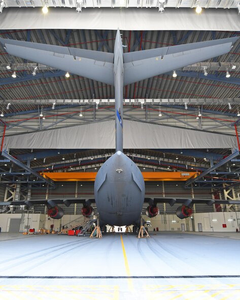 A U.S. Air Force C-17 Globemaster III is lifted inside a Qatari hangar at Al Udeid Air Base, Qatar, Feb. 25, 2017. Weather conditions such as high winds required maintenance personnel to stop working on the C-17 for safety reasons, but by parking the aircraft in the Qatari hangar, the maintainers were able to work on it uninterrupted. (U.S. Air Force photo by Senior Airman Miles Wilson)