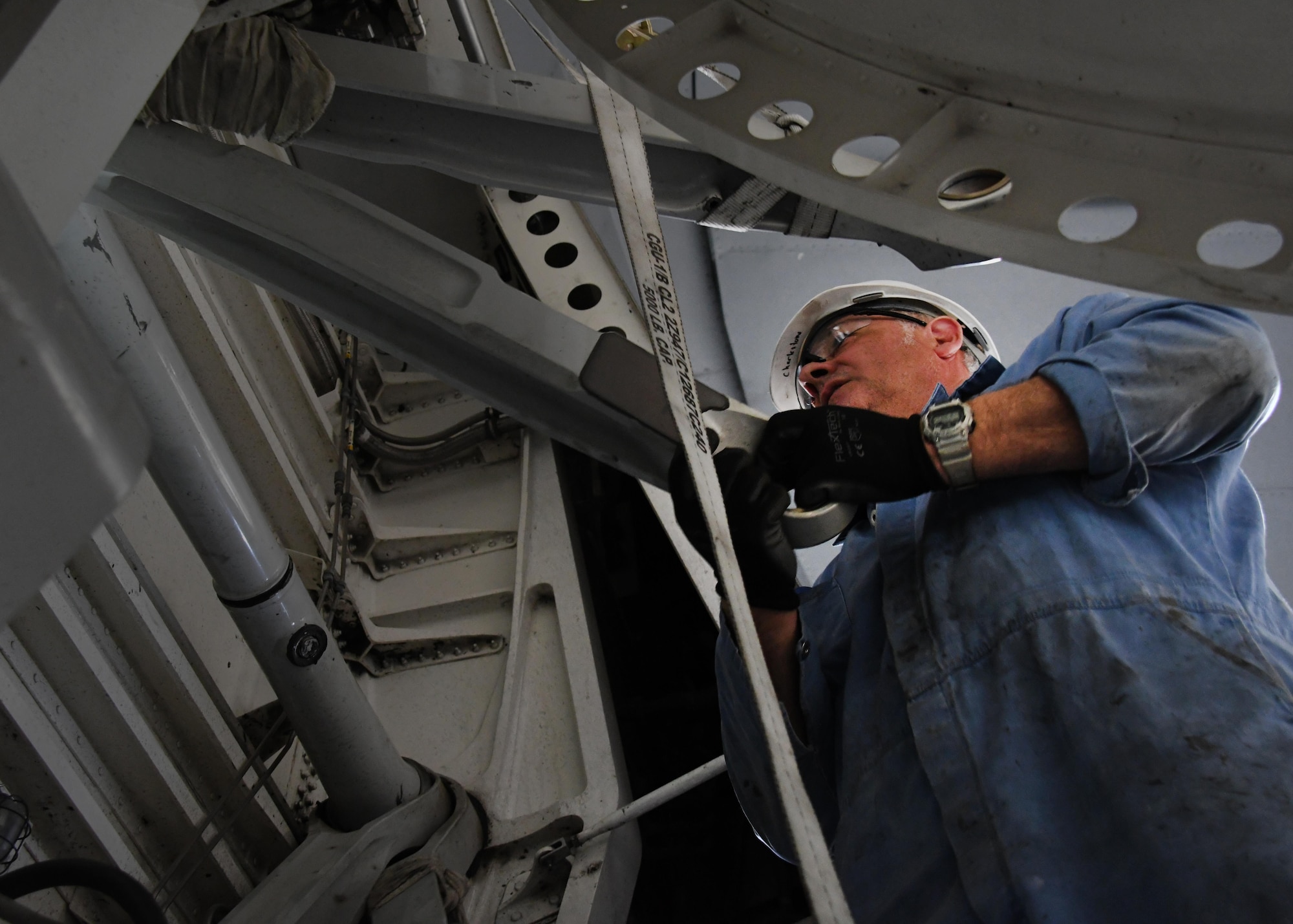 Bruce Natale, a contractor mechanic with Boeing, works on separating the upper cross shaft on a U.S. Air Force C-17 Globemaster III at Al Udeid Air Base, Qatar, Feb. 25, 2017. The C-17 aircraft was lifted up inside a Qatari hangar in order to allow maintenance on it without interruption from the weather. (U.S. Air Force photo by Senior Airman Miles Wilson)
