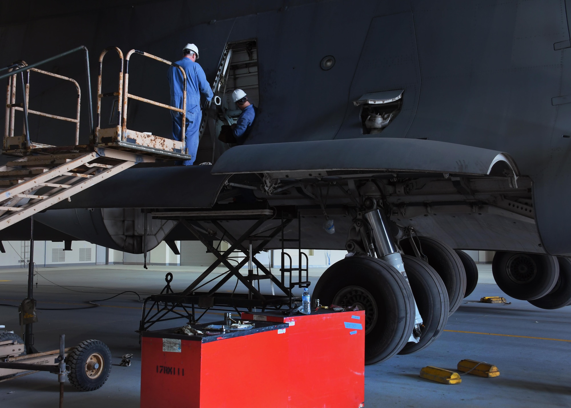 Bruce Natale, left, and Matt Sanchez, contractor mechanics with Boeing, work on a U.S. Air Force C-17 Globemaster III at Al Udeid Air Base, Qatar, Feb. 25, 2017. Two C-17 aircraft required extensive maintenance to their landing gear and required a team from Boeing to come out and fix them. (U.S. Air Force photo by Senior Airman Miles Wilson)