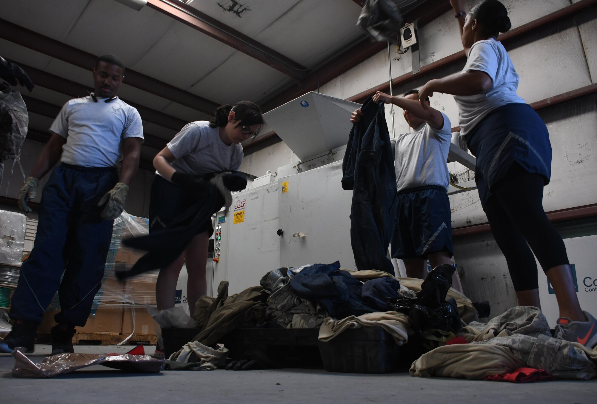 U.S. Airmen sort through uniforms at Al Udeid Air Base, Qatar, March 10, 2017. The uniforms were gathered from uniform disposal bins from around the base, and were being sorted into serviceable and unserviceable piles. Serviceable uniform items are donated to the Airman’s Attic, while the unserviceable items are shredded. (U.S. Air Force photo by Senior Airman Miles Wilson)