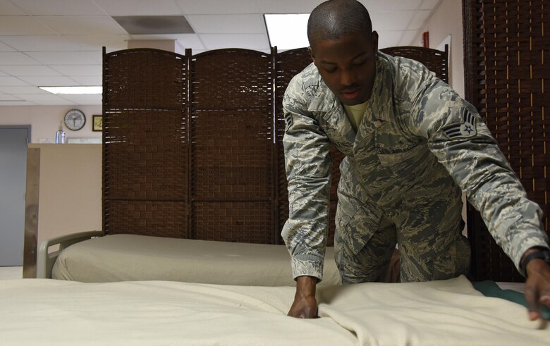 U.S. Air Force Senior Airman Jordan Marshall, an aerospace medical technician with the 379th Expeditionary Medical Group, prepares a bed for a patient in the en-route patient staging facility at Al Udeid Air Base, Qatar, March 8, 2017. Aerospace medical technicians with the 379th EMDG maintain the ERPSF which is critical to patient care during their stay and is designed to provide patient holding capabilities for personnel in transit for aeromedical evacuation. (U.S. Air Force photo by Senior Airman Cynthia A. Innocenti)