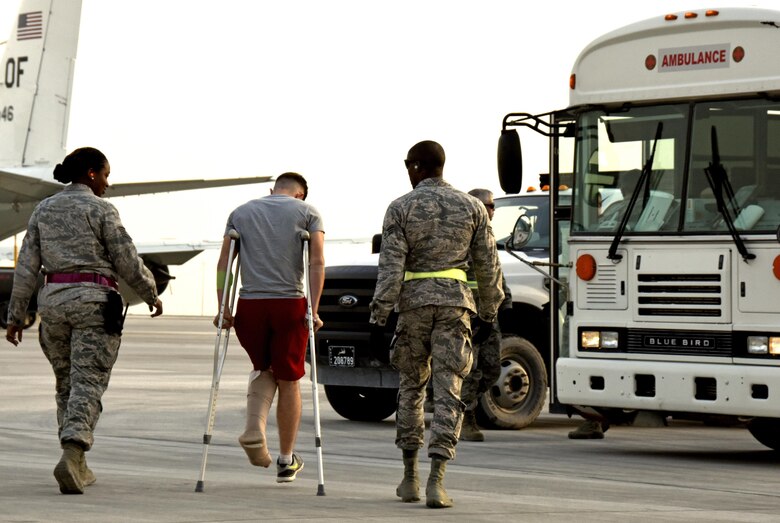 Aerospace medical technicians with the 379th Expeditionary Medical Group escort a patient from an aircraft at Al Udeid Air Base, Qatar, March 8, 2017. These technicians are a key component of transportation and support services between arrival and departure of patients from around the U.S. Central Command area of responsibility. (U.S. Air Force photo by Senior Airman Cynthia A. Innocenti)