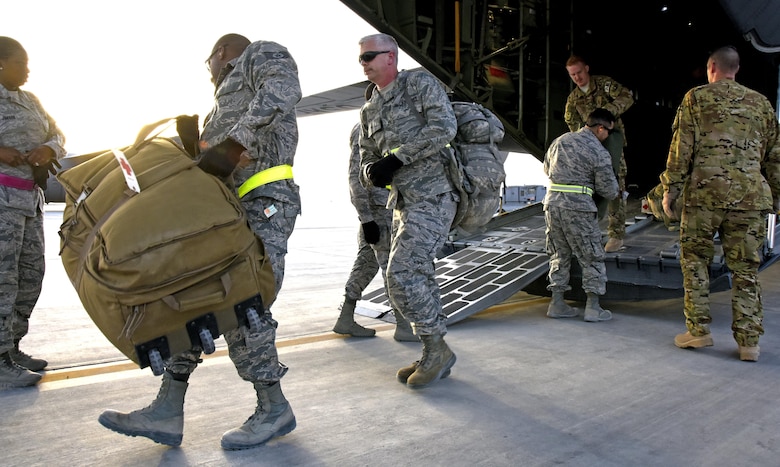 U.S. Air Force Airmen unload patients’ luggage off an aircraft at Al Udeid Air Base, Qatar, March 8, 2017. These technicians are a key component of transportation and support services between arrival and departure of patients from around the U.S. Central Command area of responsibility. (U.S. Air Force photo by Senior Airman Cynthia A. Innocenti)