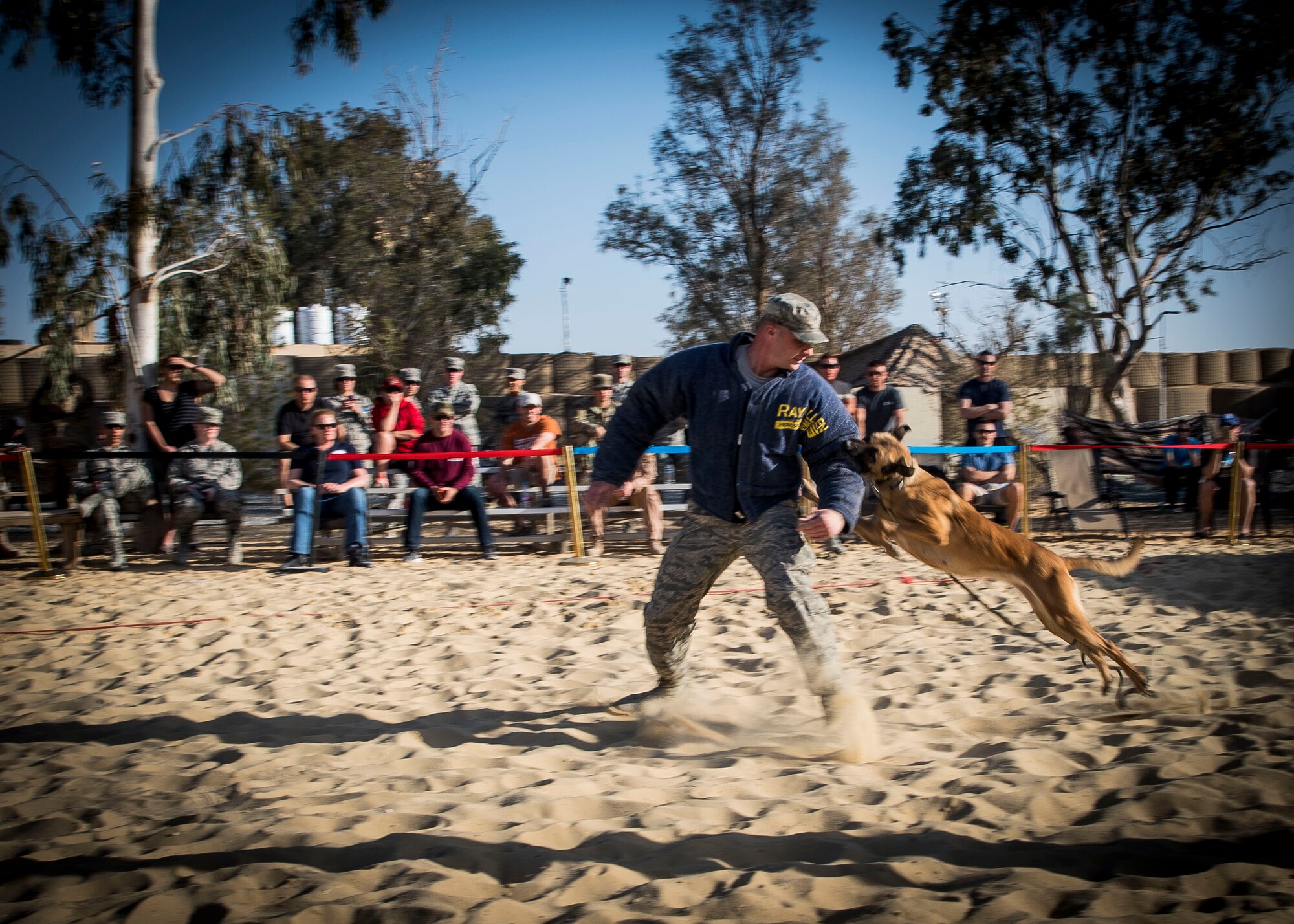 Staff Sgt. Jeffrie Kennedy, 332nd Expeditionary Security Forces Squadron military working dog handler, acts as a decoy during a demonstration scenario, Feb. 25, 2017, in Southwest Asia. MWDs are globally-mobile and multi-functional assets. (U.S. Air Force photo by Staff Sgt. Eboni Reams)