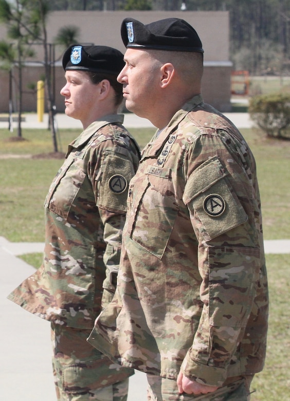 Lt. Col. Lindsay Matthews (left) and Lt. Col. James Dobrinska II (right), the Headquarters and Headquarters Battalion, U.S. Army Central incoming and outgoing commanders, stand at attention, during the change of command ceremony held at Shaw Air Force Base, S.C. March 3.