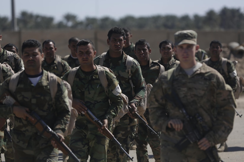 Iraqi soldiers enrolled in the Iraqi ranger course conduct a road march under the supervision of U.S. soldiers with 1st Battalion, 32nd Infantry Regiment at Camp Taji, Iraq, March 7, 2016. The Iraqi ranger course is an advanced infantry fighting school established to help train special operations soldiers for the Iraqi Army. Army photo by Sgt. Paul Sale