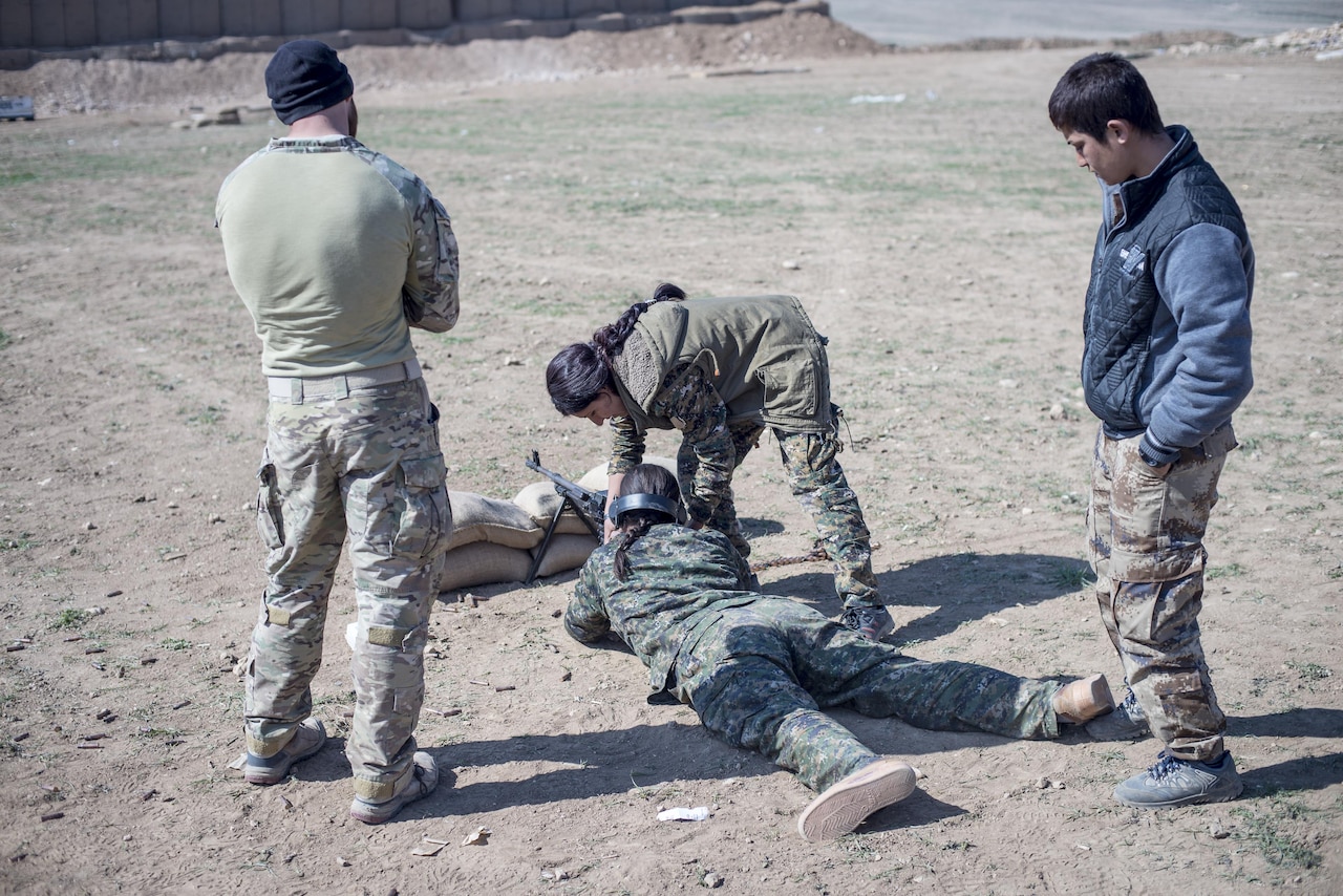 Iraqi soldiers enrolled in the Iraqi ranger course conduct a road march under the supervision of U.S. soldiers with 1st Battalion, 32nd Infantry Regiment at Camp Taji, Iraq, March 7, 2016. Army photo by Sgt. Paul Sale