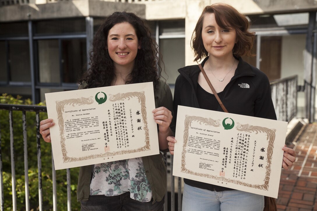 Cpl. Jessica Goldman and Lance Cpl. Scottlyn Arnold receive a certificate of appreciation from the Nago City Board of Education, at the Uruma City Ishikawa District Community Center, in Nago City, Okinawa, Japan, March 7, 2017. The certificate was presented as a thank you for their volunteer efforts during the Nago English Camp. Volunteers at the camp spent the majority of their time teaching Okinawan children how to read and write in English. Goldman, from Newtown, Pennsylvania, is a motor transportation mechanic. Arnold, from Potomac, Montana, is a motor transportations operator. Goldman and Arnold are both with Truck Company, 3rd Marine Division, III Marine Expeditionary Force. (U.S. Marine Corps Photo by Lance Cpl. Jonah Baase)
