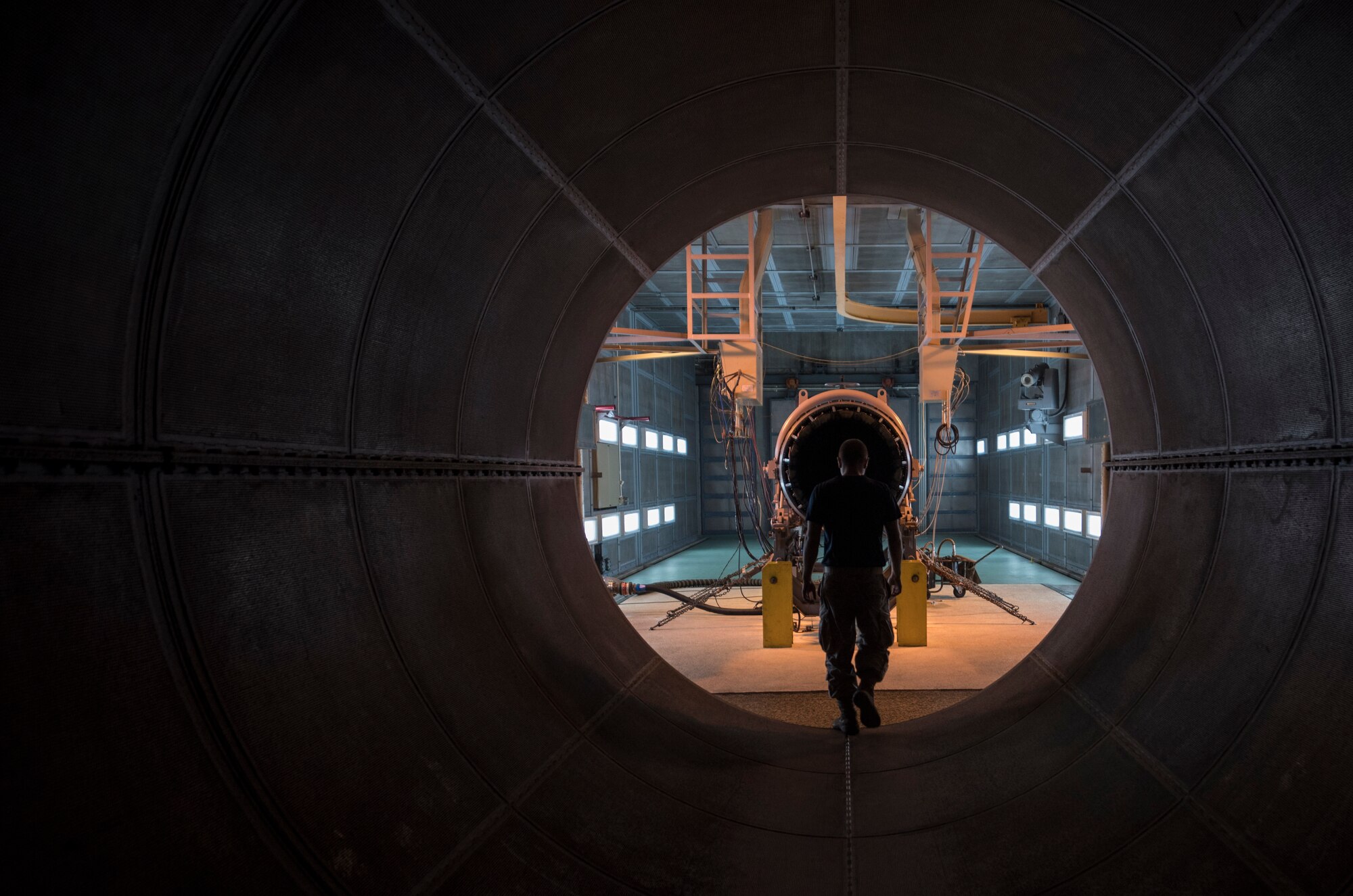 U.S. Air Force Staff Sgt. Stephen Baudo, 18th Component Maintenance Squadron aerospace propulsion craftsman, walks toward a F100/220 engine March 10, 2017, at Kadena Air Base, Japan. Engines are tested in a building specially designed to reduce the noise produced during testing by utilizing thick walls and advanced architecture. (U.S. Air Force photo by Airman 1st Class Quay Drawdy)