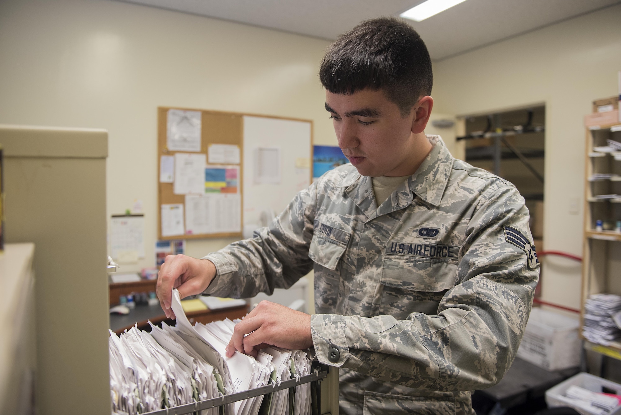 U.S. Air Force Senior Airman Calvin Cook, 18th Communications Squadron postal clerk, files member’s P.O. Box information at the Kadena Air Base Post Office March 13, 2017, on Kadena Air Base, Japan. The mission of the Post Office is to provide both personal and official mail to the service members and their families here on the island. (U.S. Air Force photo by Airman 1st Class Corey Pettis/Released)