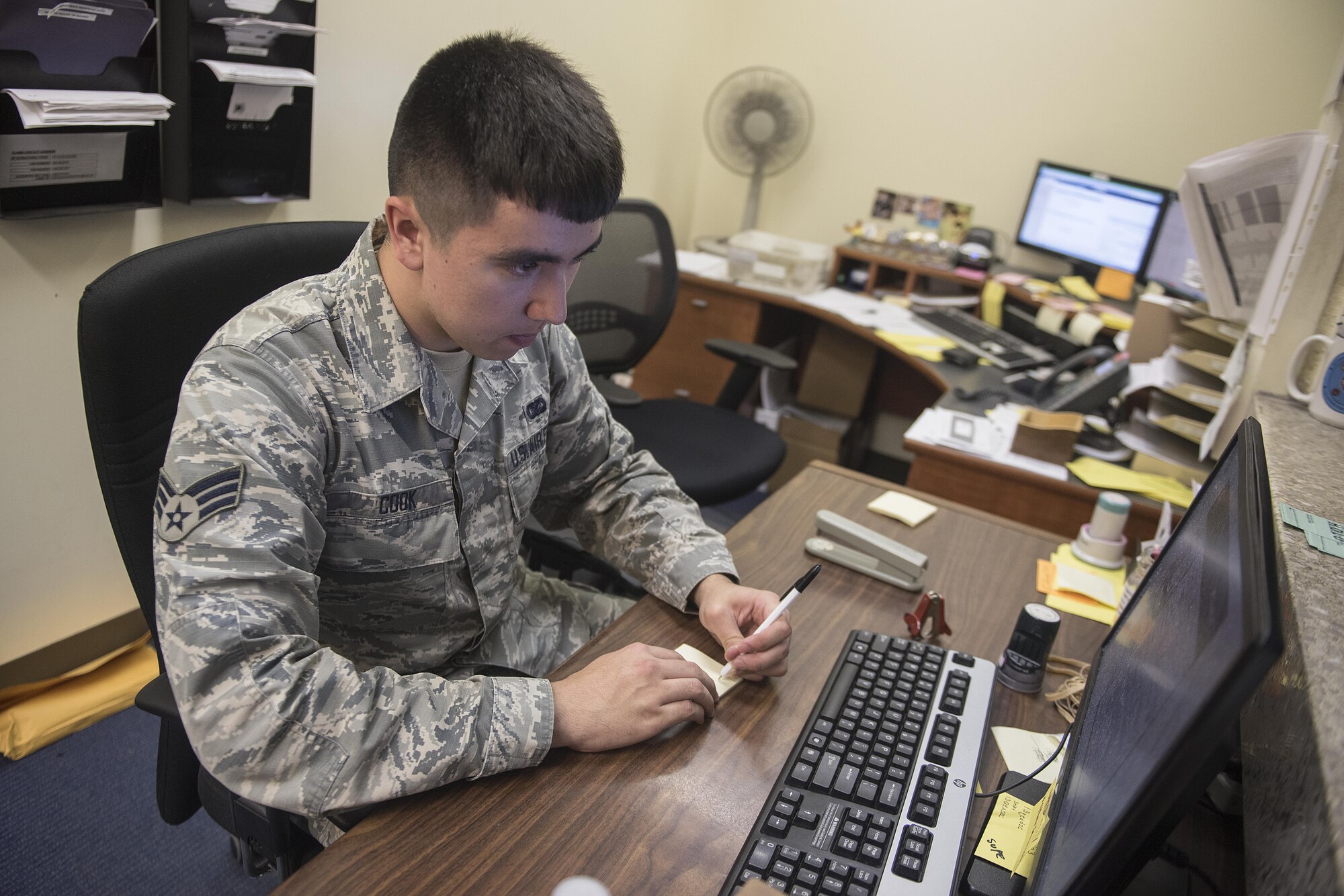 U.S. Air Force Senior Airman Calvin Cook, 18th Communications Squadron postal clerk, gathers member’s P.O. Box information at the Kadena Air Base Post Office March 13, 2017, on Kadena Air Base, Japan. The duties of the base Post Office include setting up P.O. Boxes, sorting mail, loading and unloading trucks with packages and giving parcels to customers. (U.S. Air Force photo by Airman 1st Class Corey Pettis/Released)
