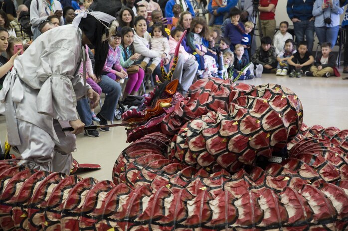 Local Japanese volunteers with the Japanese American Society perform the Kagura Dance dressed as a warrior and a dragon during the 60th Annual Culture Festival at Marine Corps Air Station Iwakuni, Japan, March 11, 2017. The festival included Japanese dance performances, decorated exhibits and traditional activities and rituals. JAS continues to bridge the U.S.-Japan friendship by providing quality cultural events and activities. (U.S. Marine Corps photo by Lance Cpl. Carlos Jimenez)