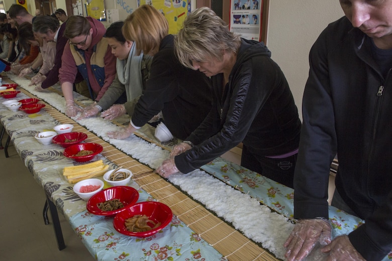 Station residents make sushi during the Japanese American Society’s 60th Annual Culture Festival at Marine Corps Air Station Iwakuni, Japan, March 11, 2017. The festival included Japanese dance performances, decorated exhibits and traditional activities and rituals. JAS continues to bridge the U.S.-Japan friendship by providing quality cultural events and activities. (U.S. Marine Corps photo by Lance Cpl. Carlos Jimenez)