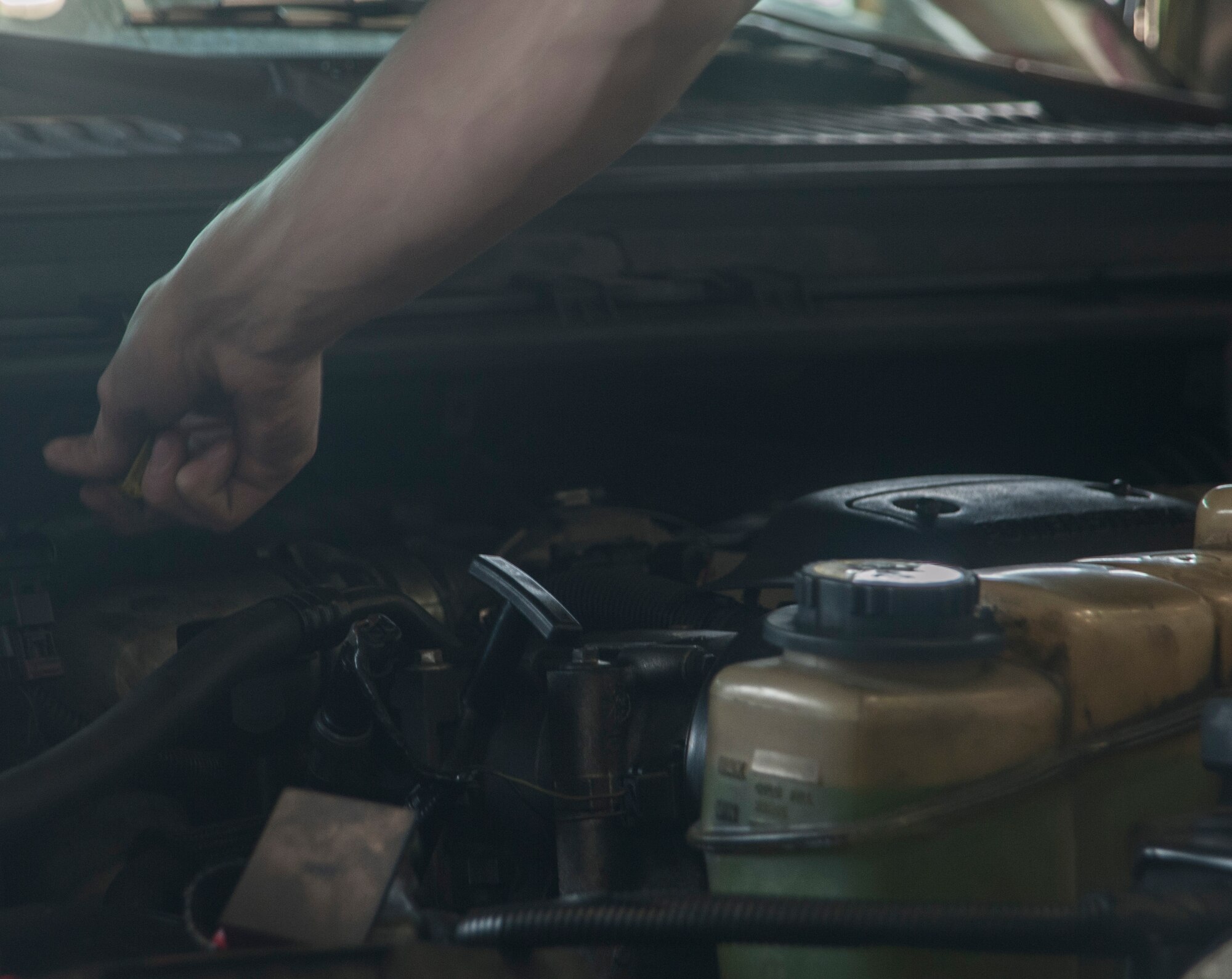 The oil levels are checked on a government vehicle March 13, 2017, at Kadena Air Base, Japan. The responsibility held by those maintaining vehicles used on the flight line is tremendous. Lives, as well as multi-million dollar pieces of equipment, are counting on the professional work conducted by the 18th LRS. (U.S. Air Force photo by Airman 1st Class Quay Drawdy)