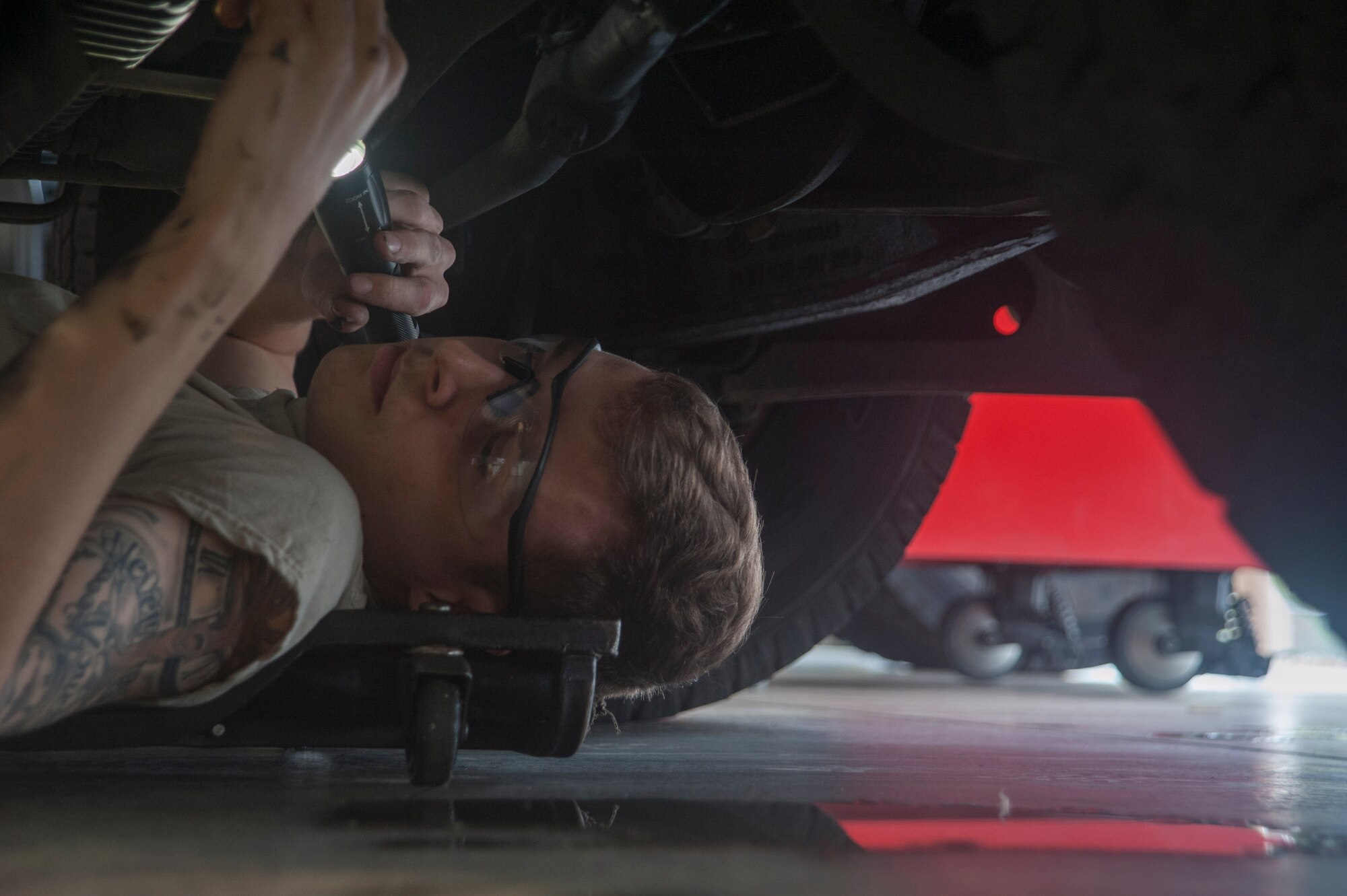 U.S. Air Force Airman 1st Class Andrew Grady, 18th Logistics Readiness Squadron special purpose vehicle maintainer, checks for fluid leaks on a government vehicle March 13, 2017, at Kadena Air Base, Japan. Attention to detail is critical when working with government vehicles. The 18th LRS ensures countless vehicles, with just as many intricate systems, are well kept and ready to perform. (U.S. Air Force photo by Airman 1st Class Quay Drawdy)