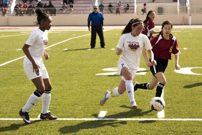 A player on the Matthew C. Perry Lady Samurai soccer team competes against a player from Marist Brothers International School during the Western Japan Athletic Association Girls Soccer Tournament on M.C. Perry Sports Field at Marine Corps Air Station, Iwakuni, Japan, March 11,2017.  The WJAA is comprised of international and Department of Defense schools. M.C. Perry is one of only two DoD schools that participated.  (U.S. Marine Corps photo by Pfc. Stephen Campbell)