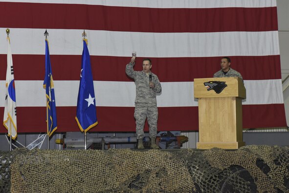 Maj. Gen. James Slife, Deputy Chief of Staff for the UN Command and U.S. Forces Korea, holds up a glass of water for a toast during the Maintenance Professional of the Year banquet March 10, 2017 at Kunsan Air Base, Republic of Korea. Slife, who presided over the event, and members from the 8th Fighter Wing gathered in Hangar 3 here to recognize airmen from multiple maintenance career fields for their outstanding achievements in 2016. (U.S. Air Force photo by Senior Airman Michael Hunsaker/Released)