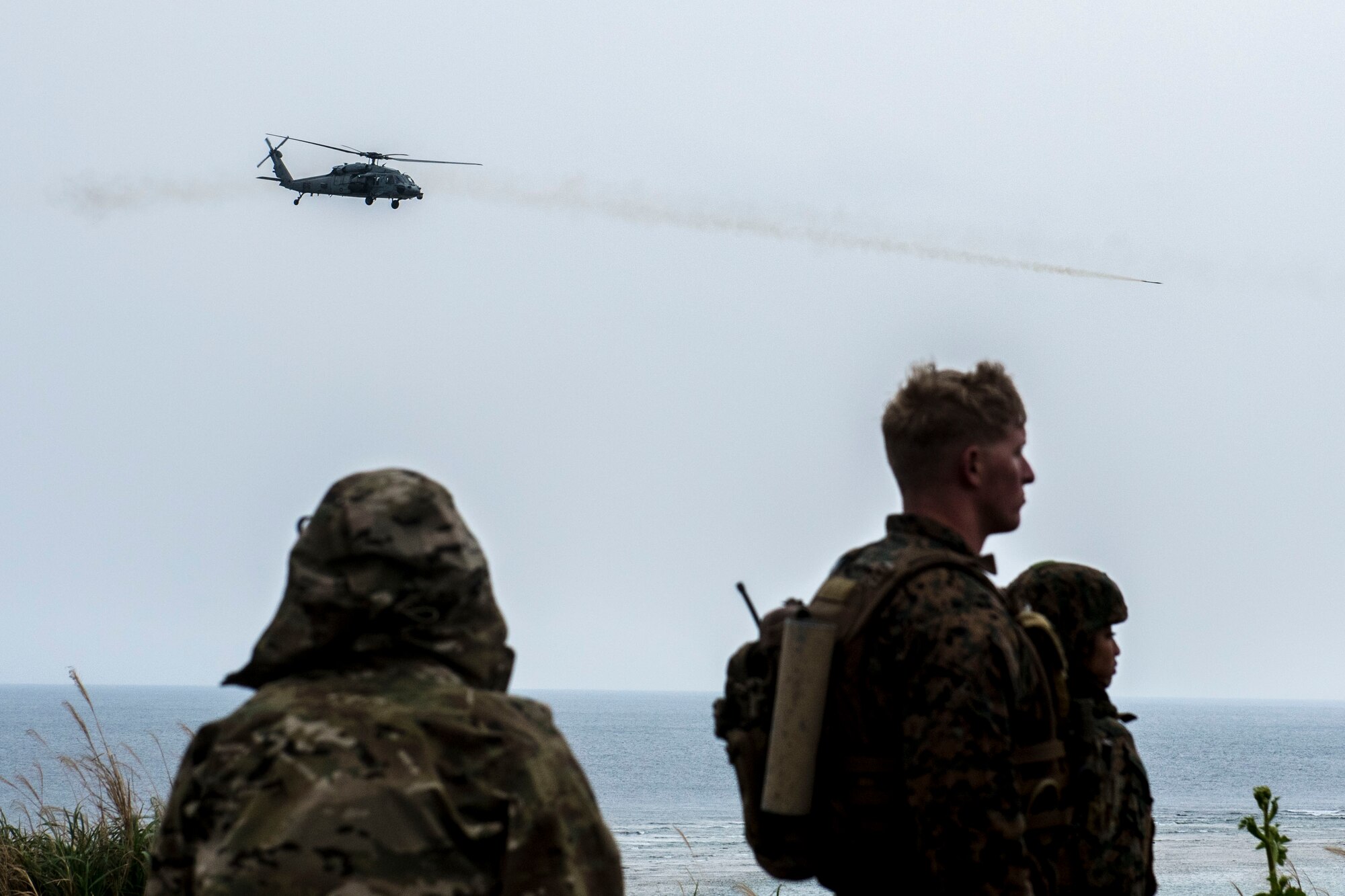 U.S. Navy HH-60 Sea Hawk from the Helicopter Sea Combat Unit 12 fires a captive-air-training missile March 10, 2017, at the Irisuna Jima Training Range, Okinawa, Japan. Navy helicopters were called in for air-to-ground attacks by service members from the 320th Special Tactics Squadron and the 5th Air Naval Gunfire Liaison Company, III Marine Expeditionary Force during the joint training exercise. (U.S. Air Force photo by Senior Airman John Linzmeier)