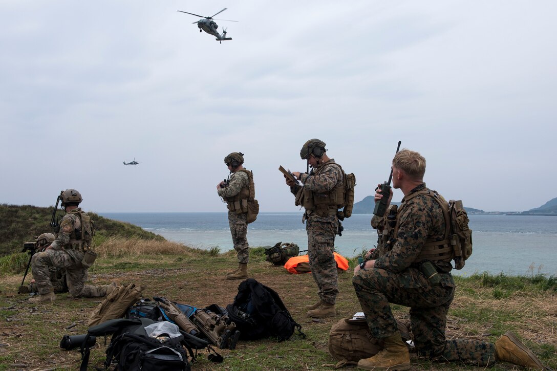 A U.S. Air Force combat control Airman from the 320th Special Tactics Squadron, and U.S. Marine Corps marine joint terminal attack controllers from the 5th Air Naval Gunfire Liaison Company, III Marine Expeditionary Force, call in close air support March 10, 2017, at the Irisuna Jima Training Range, Okinawa, Japan. Members of the 320th STS and III MEF frequently training together to in order to maintain an understanding of each other's practices and  capabilities. Combat control Airmen and JTAC Marines are experts at calling in air support in hostile, complex environments. (U.S. Air Force photo by Senior Airman John Linzmeier)