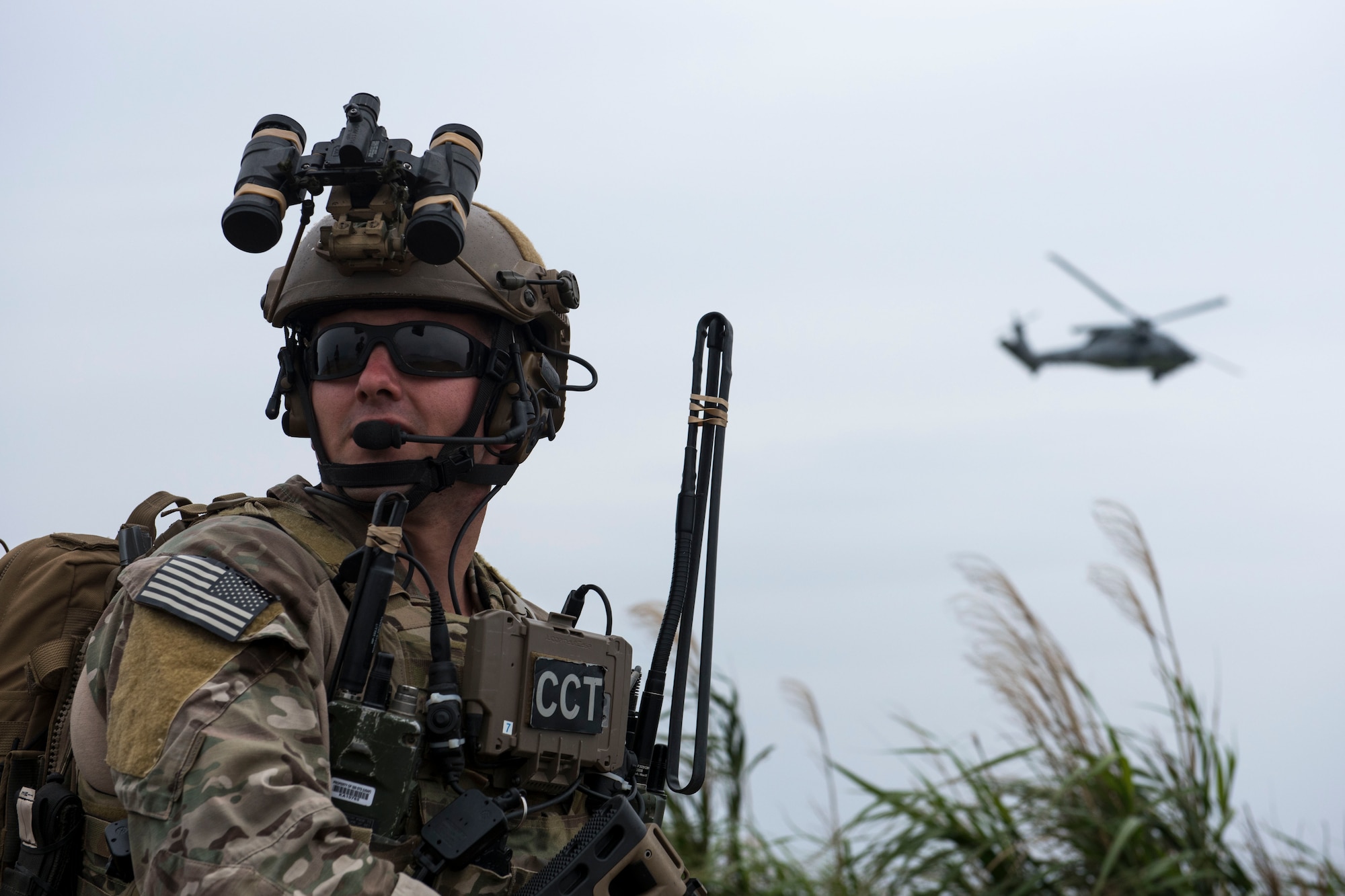 A U.S. Air Force combat control Airman from the 320th Special Tactics Squadron communicates with a U.S. Navy HH-60 Sea Hawk from the Helicopter Sea Combat Unit 12 during a training exercise March 10, 2017, at the Irisuna Jima Training Range, Okinawa, Japan. Combat controllers execute complex air-to-ground missions that integrate ground-based radio operations with fixed and rotary wing aircraft in combat environments. (U.S. Air Force photo by Senior Airman John Linzmeier)
