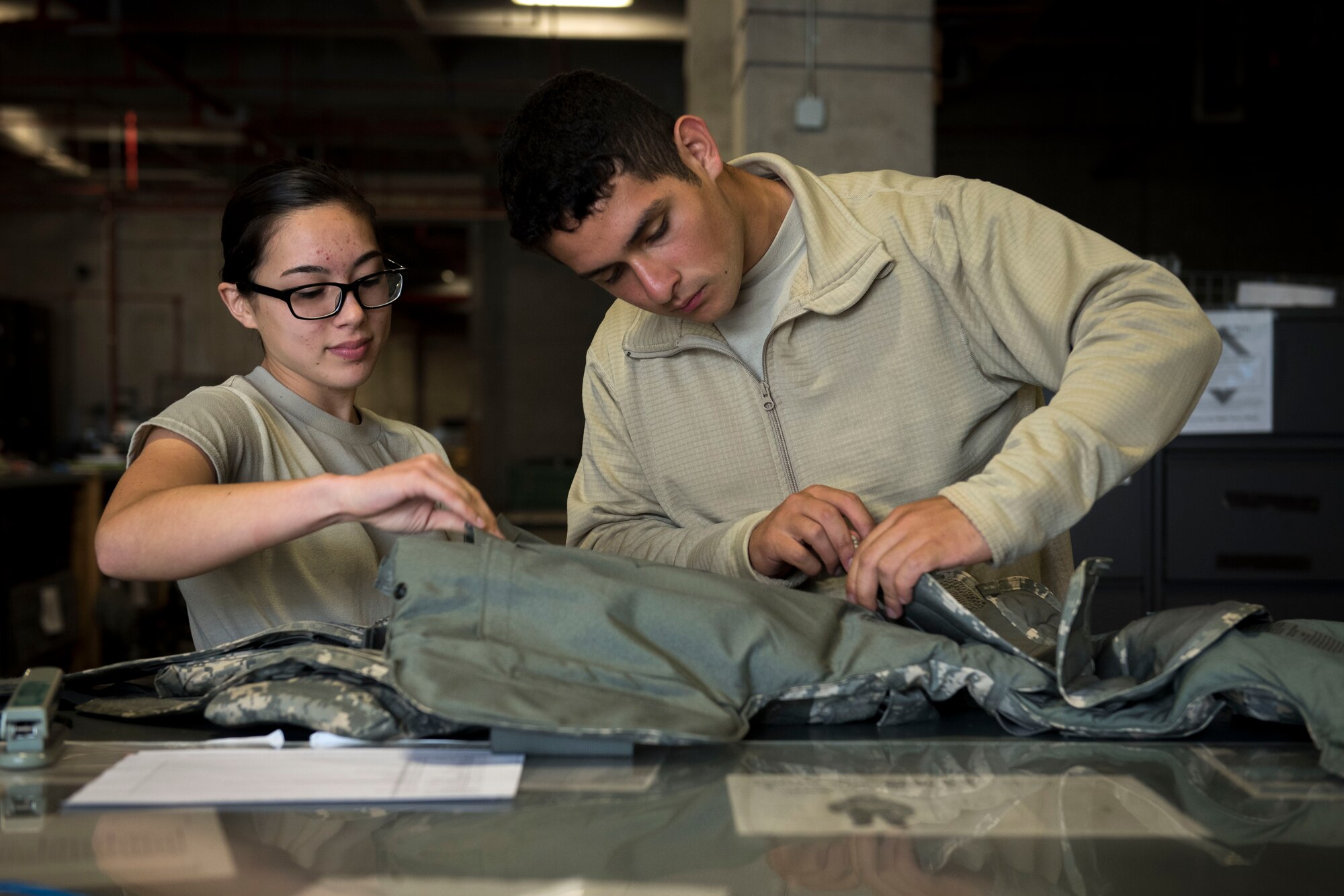 U.S. Air Force Airman Sienna Korea Hinze and Airman Christopher Gomezcoello, 18th Logistics Readiness Squadron material management technicians, service individual protective equipment March 13, 2017, at Kadena Air Base, Japan.
The Individual Protective Equipment Shop issues mobility bags, deployment and training gear to all active-duty service members assigned to or in transit through Kadena. (U.S. Air Force photo by Senior Airman John
Linzmeier)