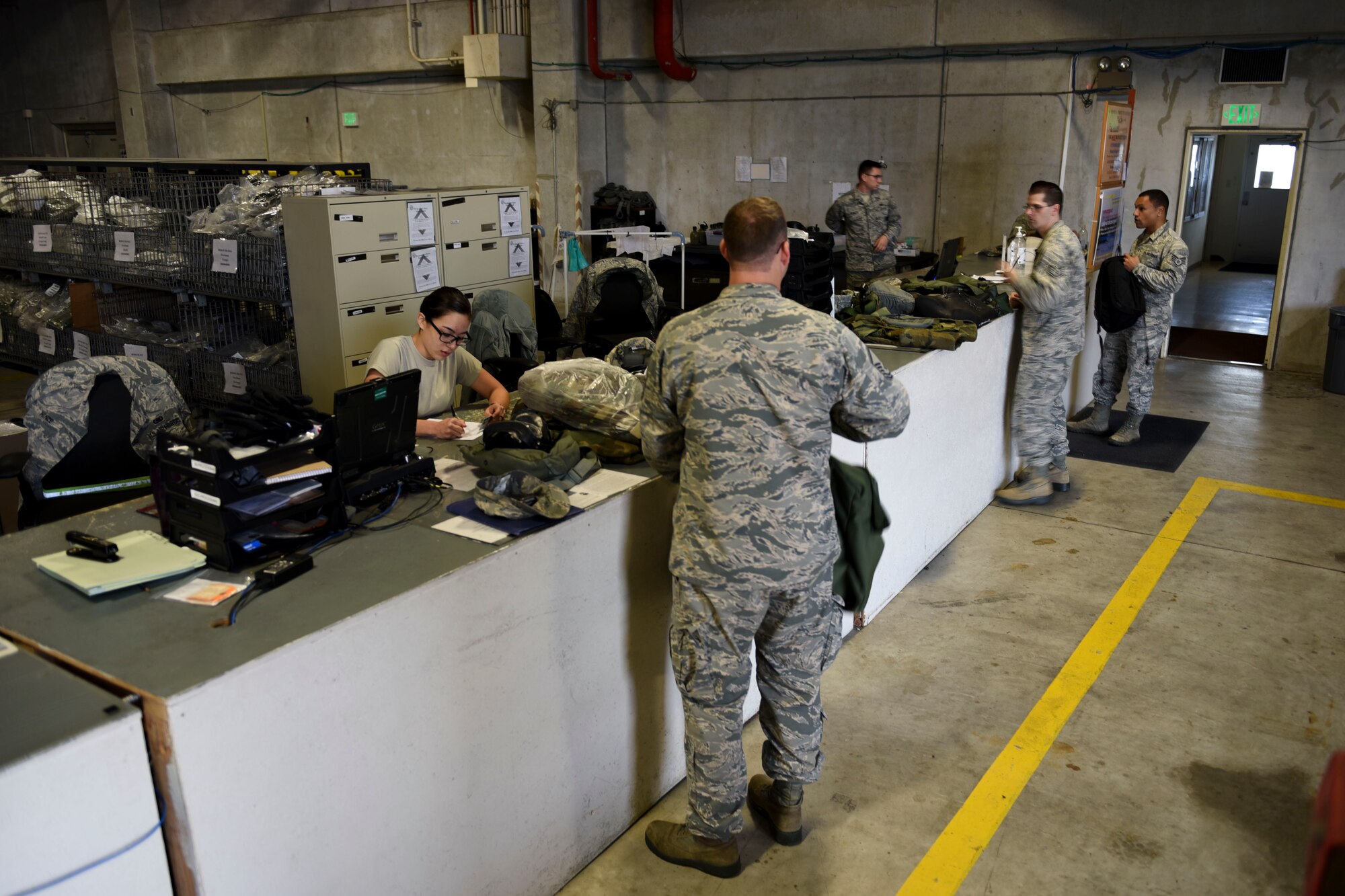 Members of Team Kadena visit the 18th Logistics Readiness Squadron Individual Protective Equipment Shop to turn in equipment March 13, 2017, at Kadena Air Base, Japan. The IPE Shop issues equipment such as gas masks, sleeping bags and tactical vests to Airmen for training purposes and deployments. (U.S. Air Force photo by Senior Airman John Linzmeier)