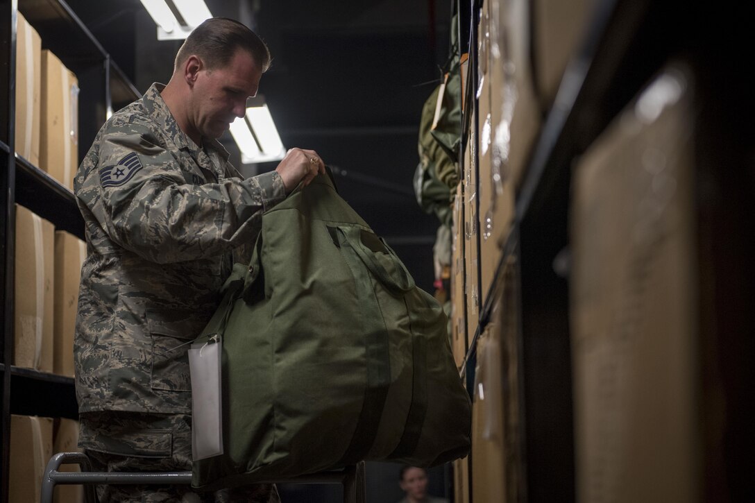U.S. Air Force Staff Sgt. Christopher Clark, 445th Logistics Readiness Squadron material management technician, inspects individual protective equipment March 13, 2017, at Kadena Air Base, Japan. Clark and other reservist Airmen from Wright-Patterson Air Force Base, Ohio, are temporarily working in the 18th LRS's IPE Shop as part of their annual overseas assignment. (U.S. Air Force photo by Senior Airman John Linzmeier)