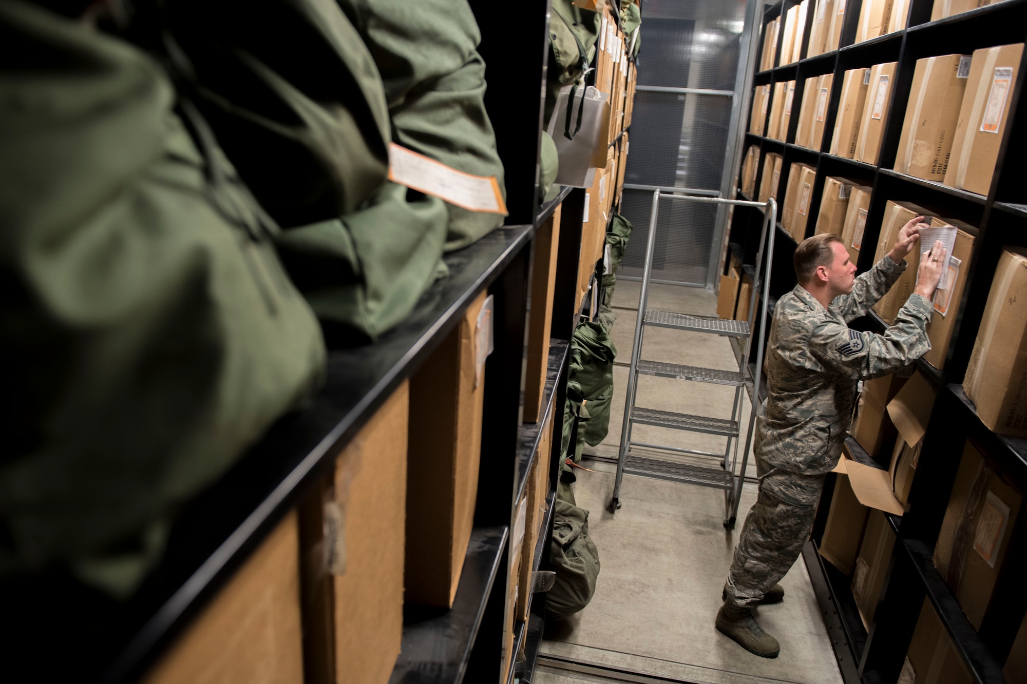 U.S. Air Force Staff Sgt. Christopher Clark, 445th Logistics Readiness Squadron material management technician, inspects individual protective equipment March 13, 2017, at Kadena Air Base, Japan. Inspections and equipment issues are practiced to ensure personnel are prepared for unforeseen circumstances. (U.S. Air Force photo by Senior Airman John Linzmeier)